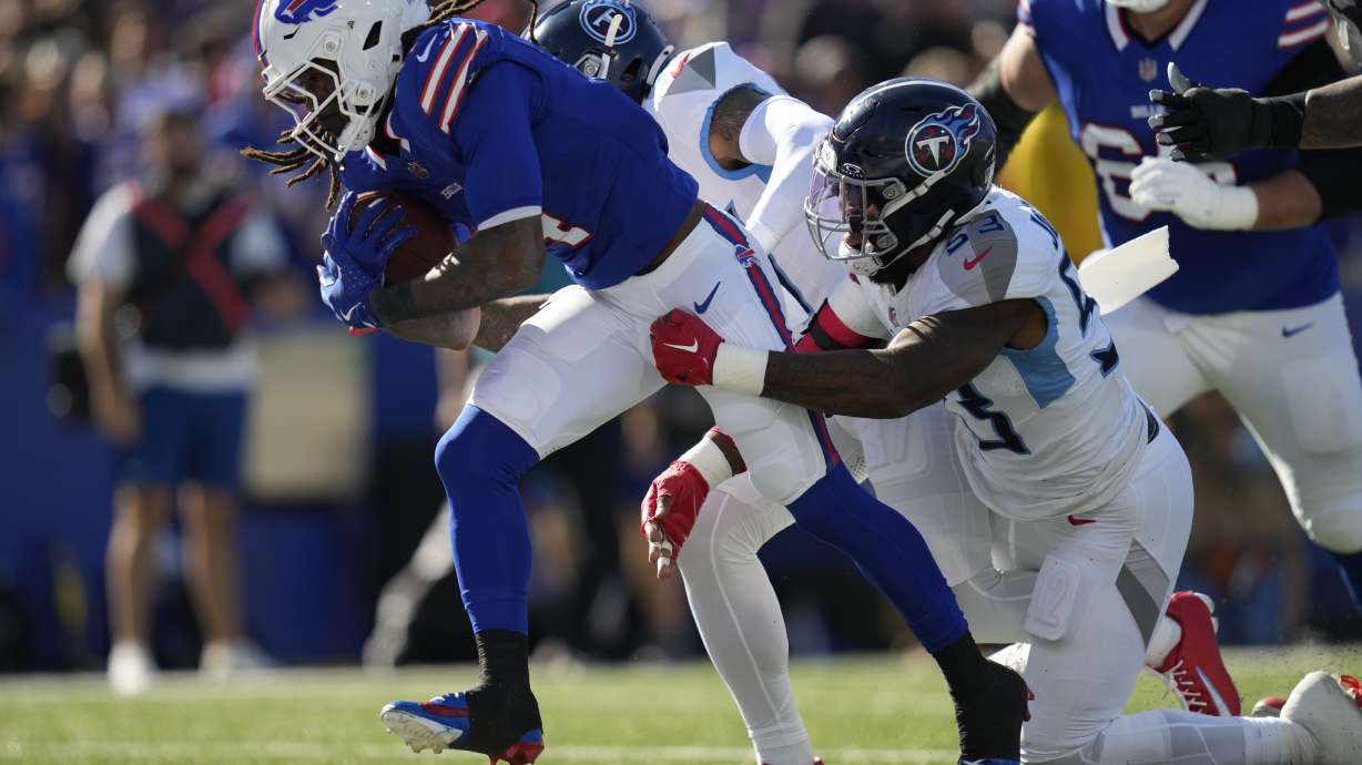 Buffalo Bills running back James Cook, left, runs for a touchdown past Tennessee Titans linebacker Ernest Jones IV (53) during the first half of an NFL football game Sunday, Oct. 20, 2024, in Orchard Park, N.Y.