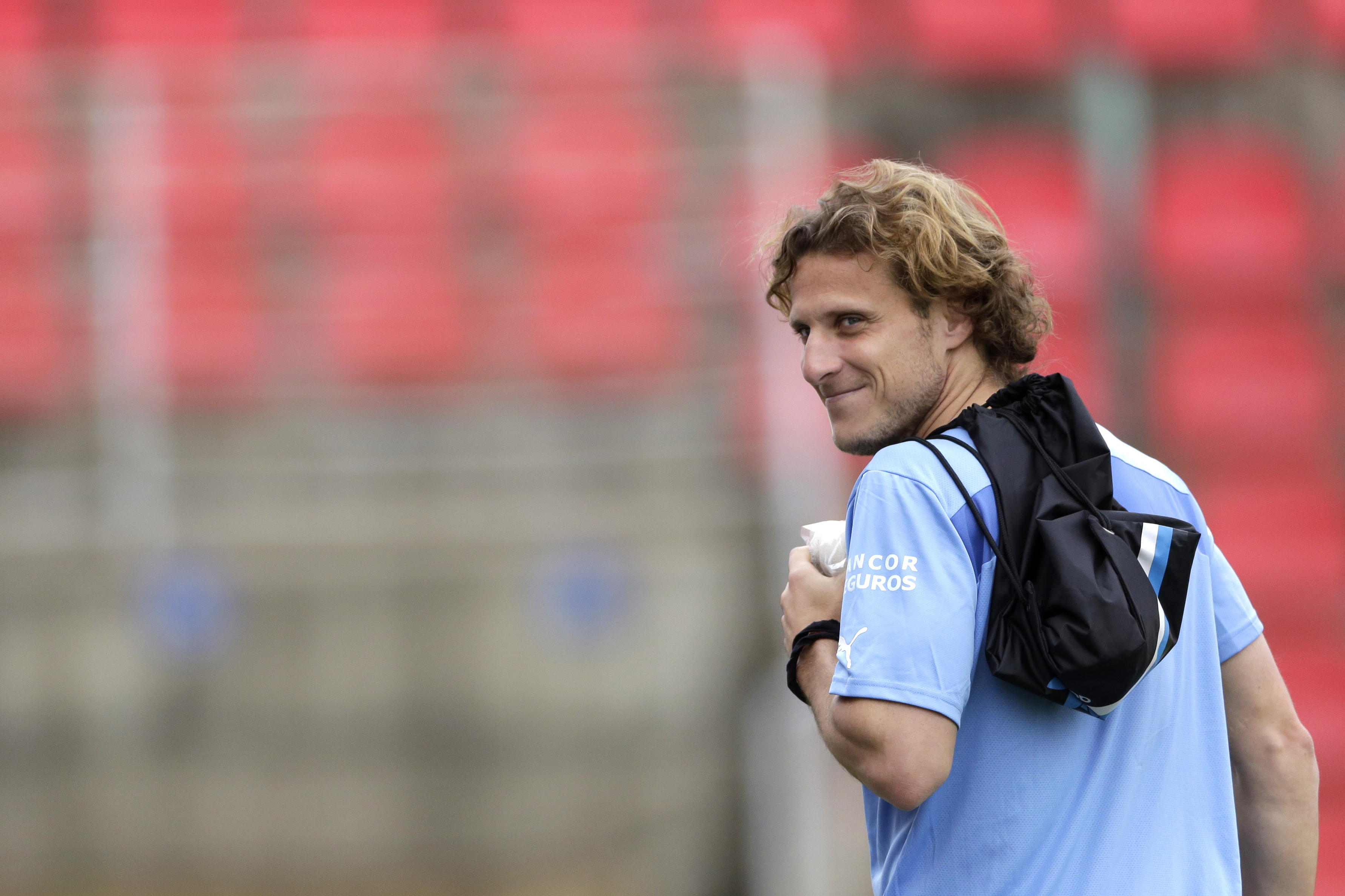 FILE - Uruguay's Diego Forlan arrives to a practice session at Arena do Jacare Stadium in Sete Lagoas, Brazil, June 12, 2014.