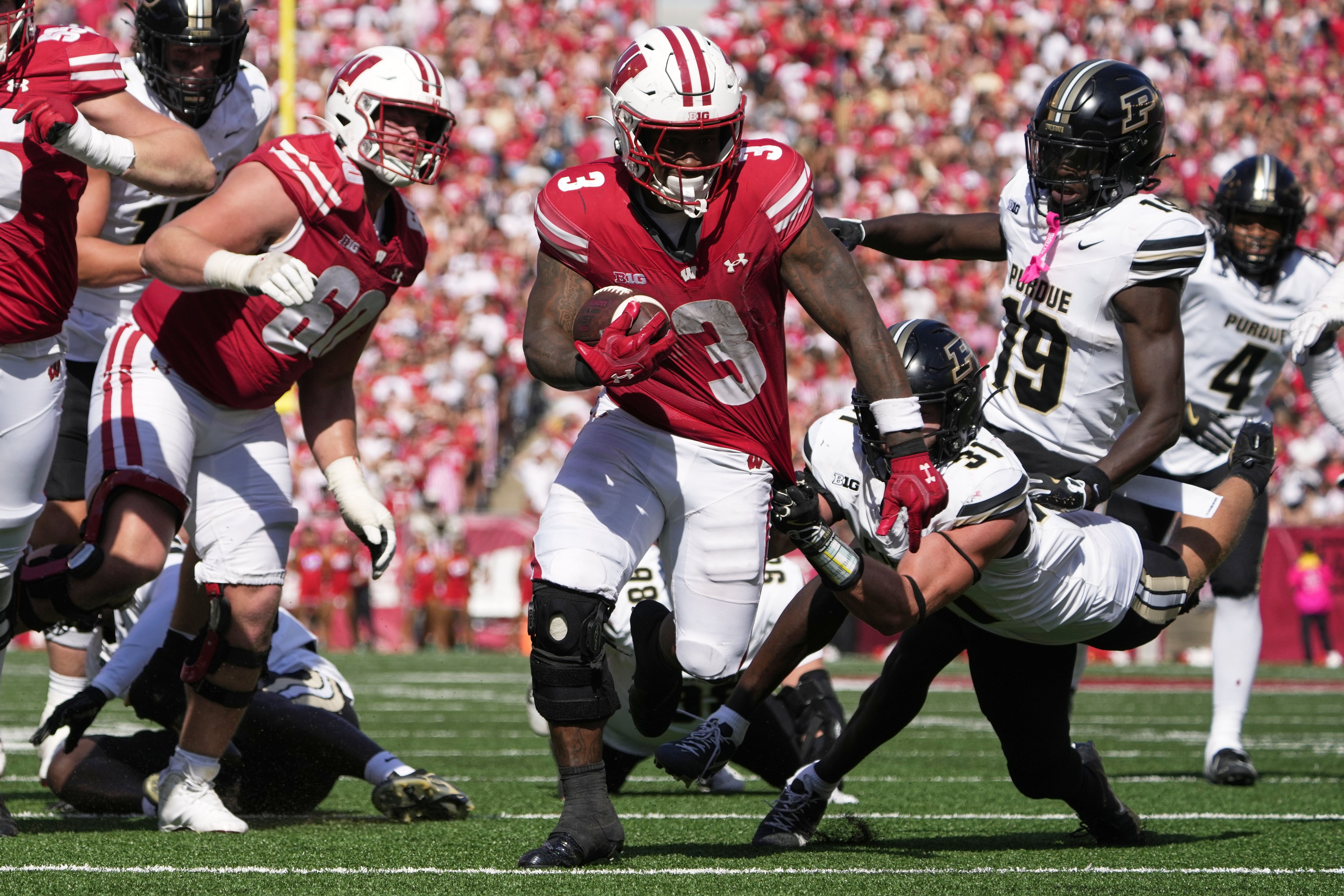 Wisconsin's Tawee Walker (3) gets away from Purdue's Dillon Thieneman (31) for a touchdown during the second half of an NCAA college football game Saturday, Oct. 5, 2024, in Madison, Wis. 