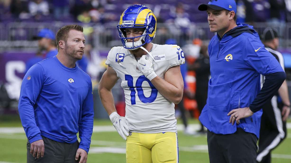 FILE - Los Angeles Rams head coach Sean McVay, left, and offensive coordinator Kevin O'Connell, right, talk with wide receiver Cooper Kupp (10) on the field during warmups prior to an NFL football game against the Minnesota Vikings, Dec. 26, 2021, in Minneapolis.