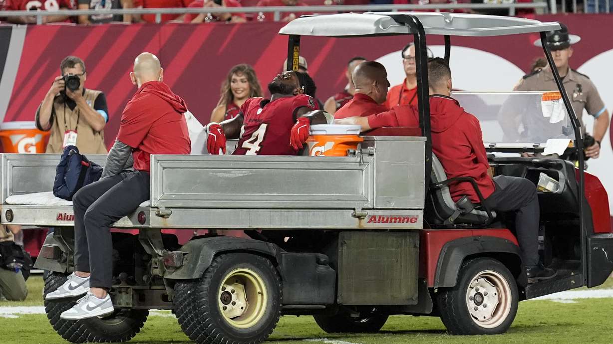 Tampa Bay Buccaneers wide receiver Chris Godwin (14) is carted off of the field after an injury during the second half of an NFL football game against the Baltimore Ravens, Monday, Oct. 21, 2024, in Tampa, Fla.