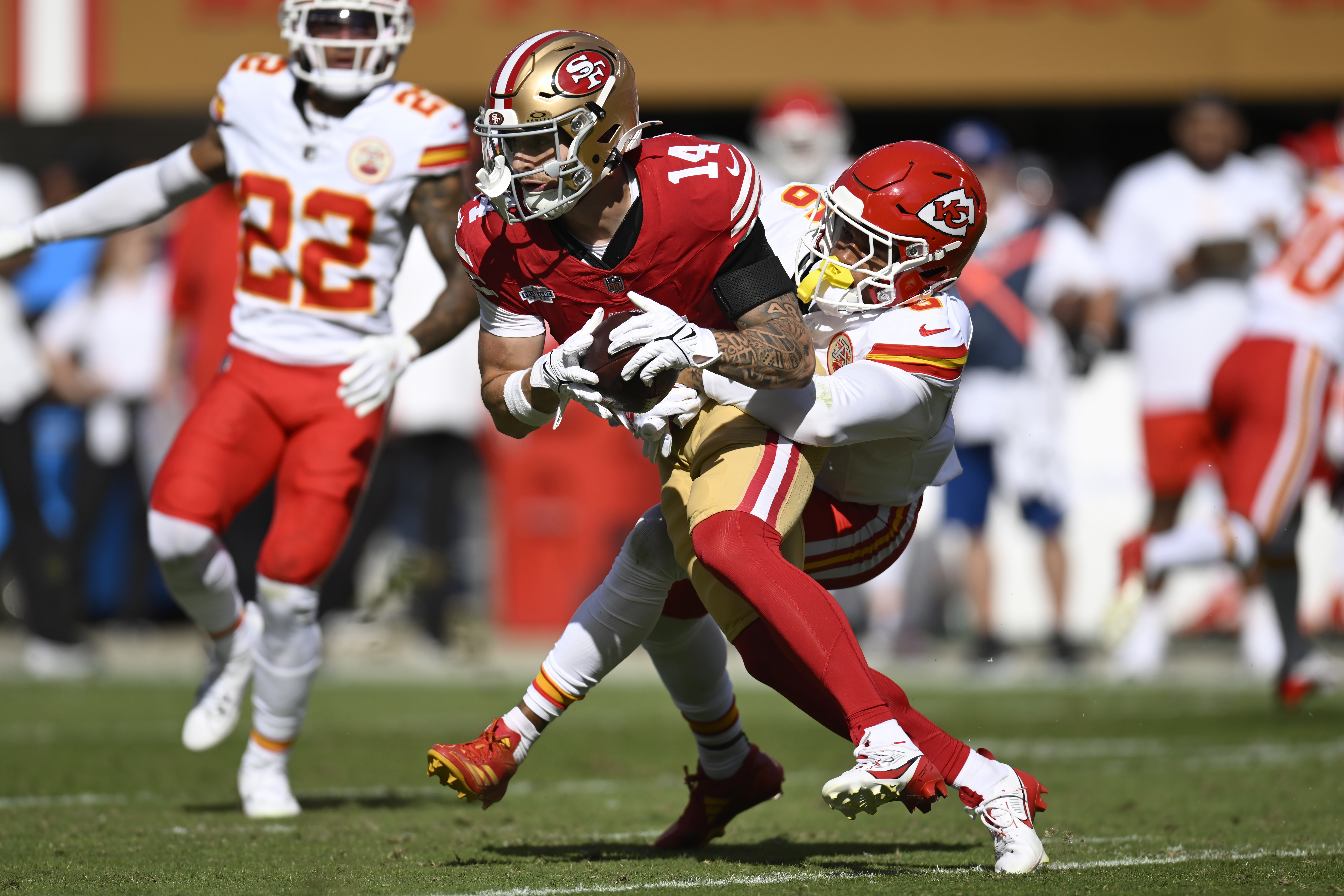 San Francisco 49ers wide receiver Ricky Pearsall (14) catches a pass against Kansas City Chiefs safety Bryan Cook (6) during the first half of an NFL football game in Santa Clara, Calif., Sunday, Oct. 20, 2024.
