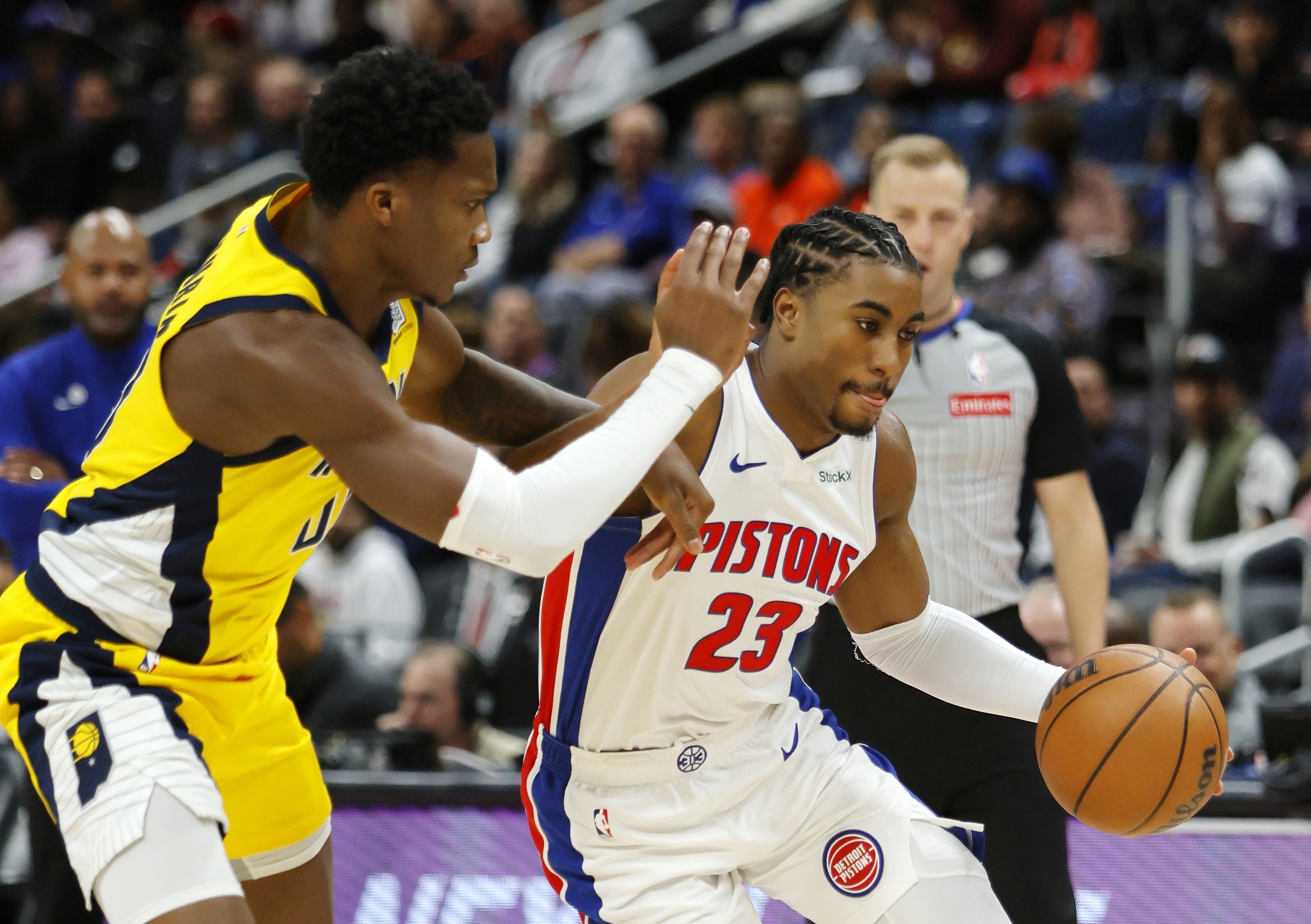 Detroit Pistons guard Jaden Ivey (23) drives against Indiana Pacers guard Bennedict Mathurin during the first half of an NBA basketball game Wednesday, Oct. 23, 2024, in Detroit.