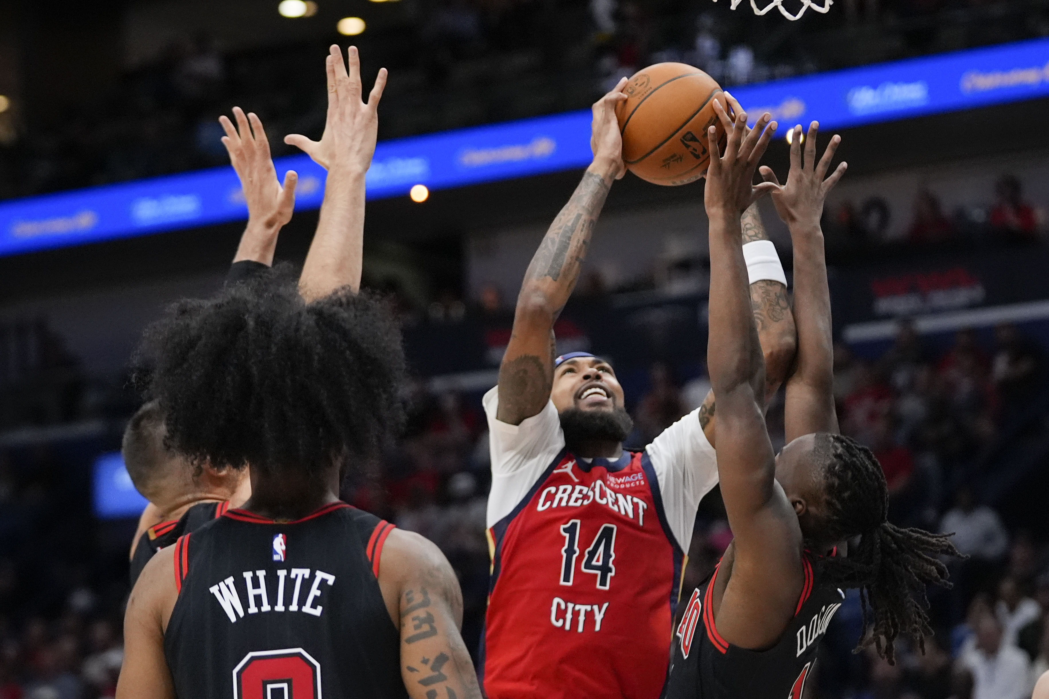 New Orleans Pelicans forward Brandon Ingram (14) goes to the basket against Chicago Bulls guard Ayo Dosunmu in the first half of an NBA basketball game in New Orleans, Wednesday, Oct. 23, 2024.