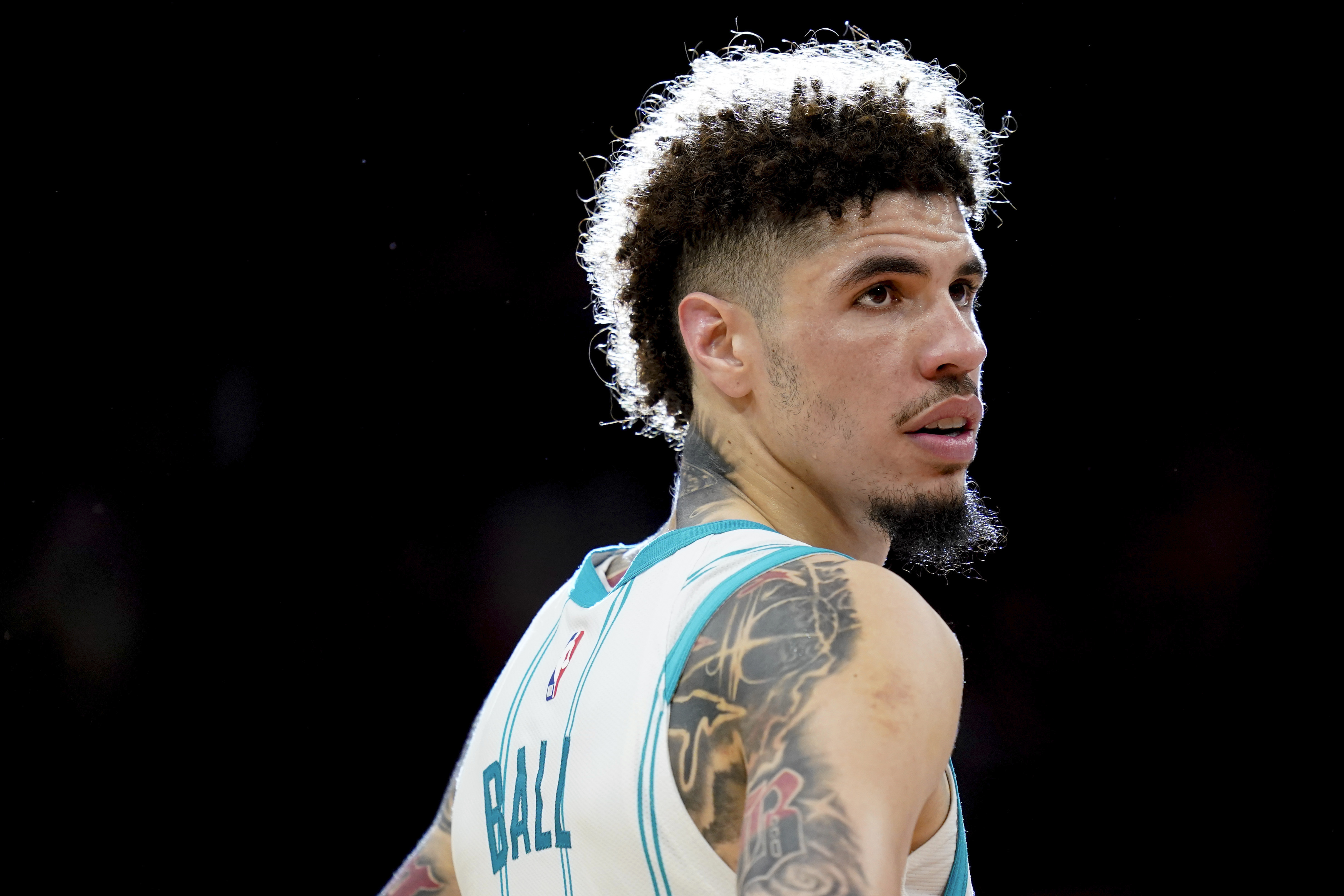 Charlotte Hornets guard LaMelo Ball watches a free throw during the second half of an NBA basketball game against the Houston Rockets, Wednesday, Oct. 23, 2024, in Houston.