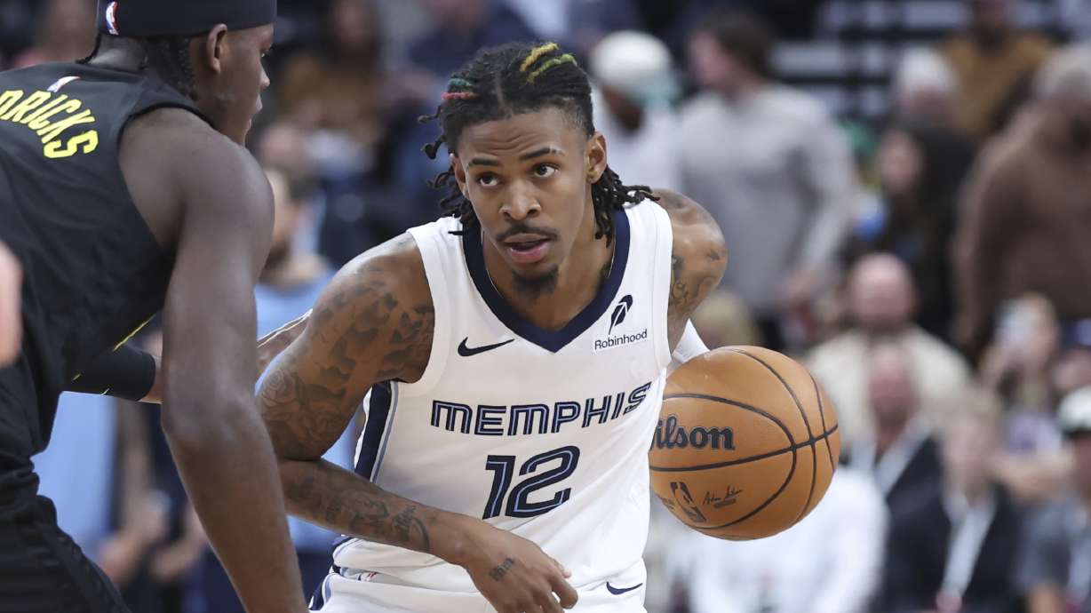 Memphis Grizzlies guard Ja Morant (12) holds the ball against the Utah Jazz during the first half of an NBA basketball game, Wednesday, Oct. 23, 2024, in Salt Lake City.