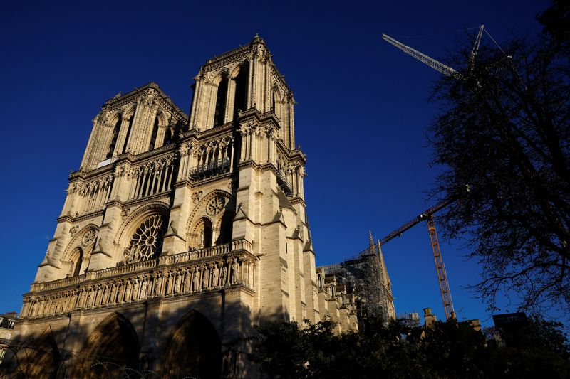 Cranes are seen around the Notre-Dame de Paris Cathedral, which was ravaged by a fire in 2019, as restoration works continue before its reopening, in Paris, Wednesday.