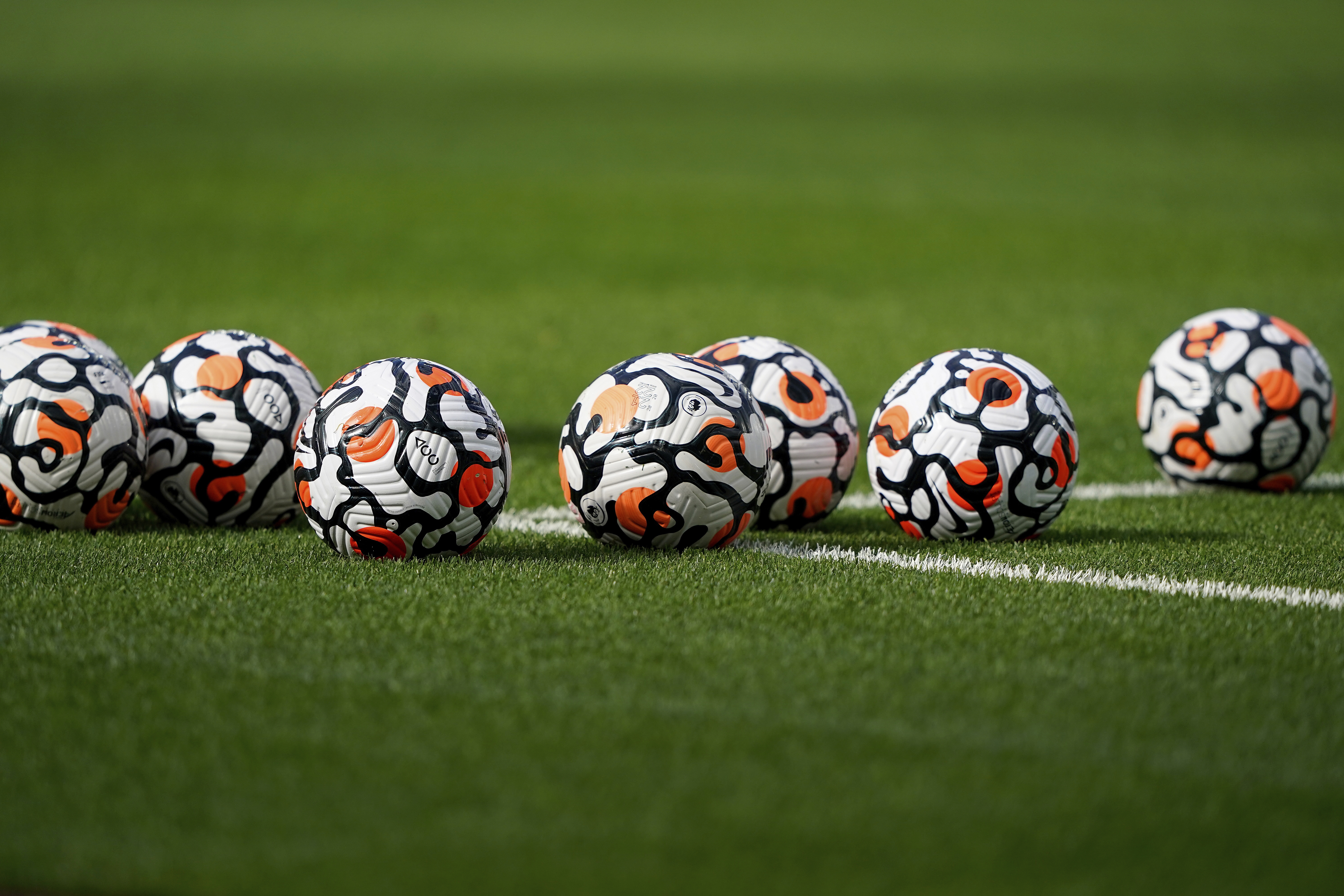 Balls sit on the pitch before an English Premier League soccer match between West Ham United and Brentford at London Stadium in London, on Oct. 3, 2021.