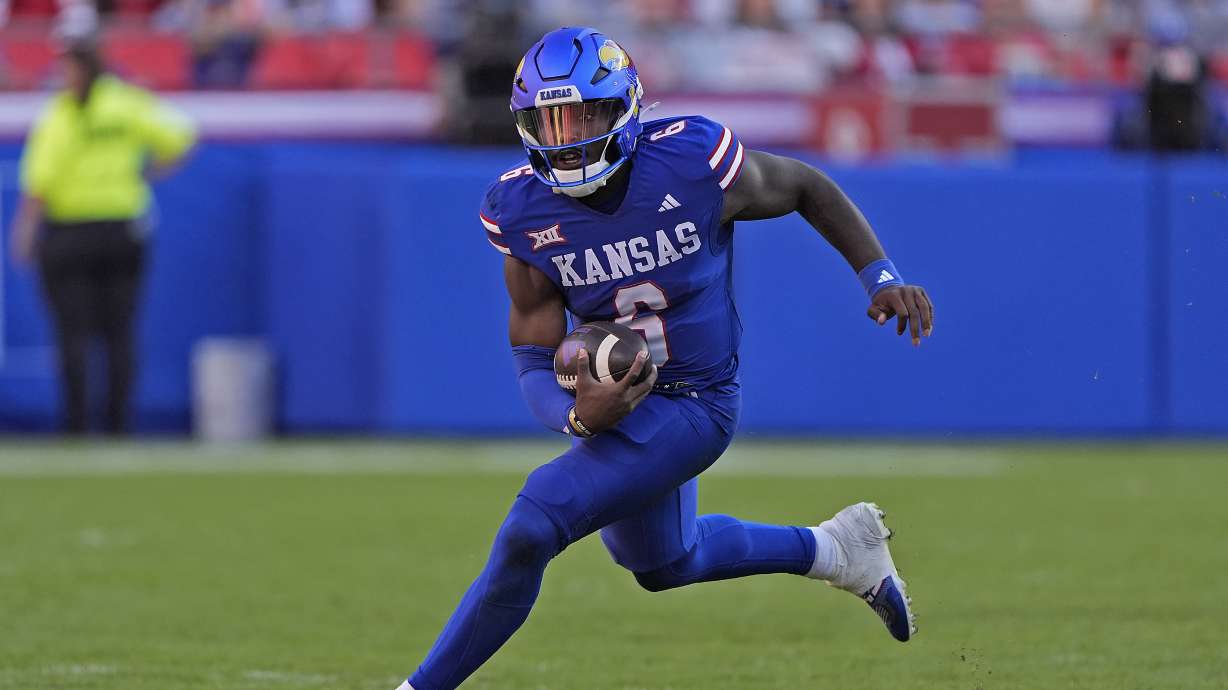 Kansas quarterback Jalon Daniels runs the ball during the second half of an NCAA college football game against Houston, Saturday, Oct. 19, 2024, in Kansas City, Mo. Kansas won 42-14.