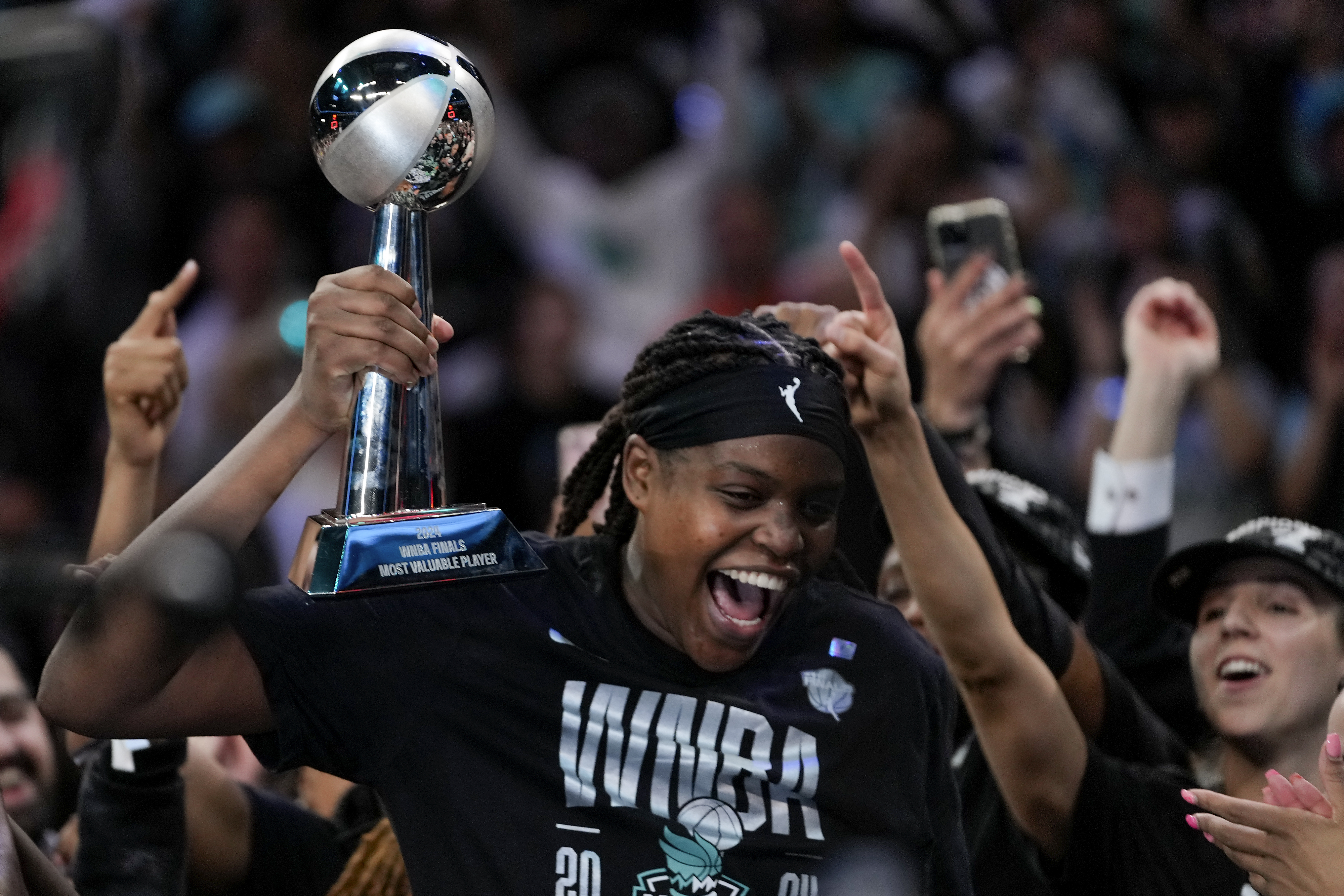 New York Liberty forward Jonquel Jones (35) reacts after being given the MVP Award after winning the championship against the Minnesota Lynx in Game 5 of the WNBA basketball final series, Sunday, Oct. 20, 2024, in New York.