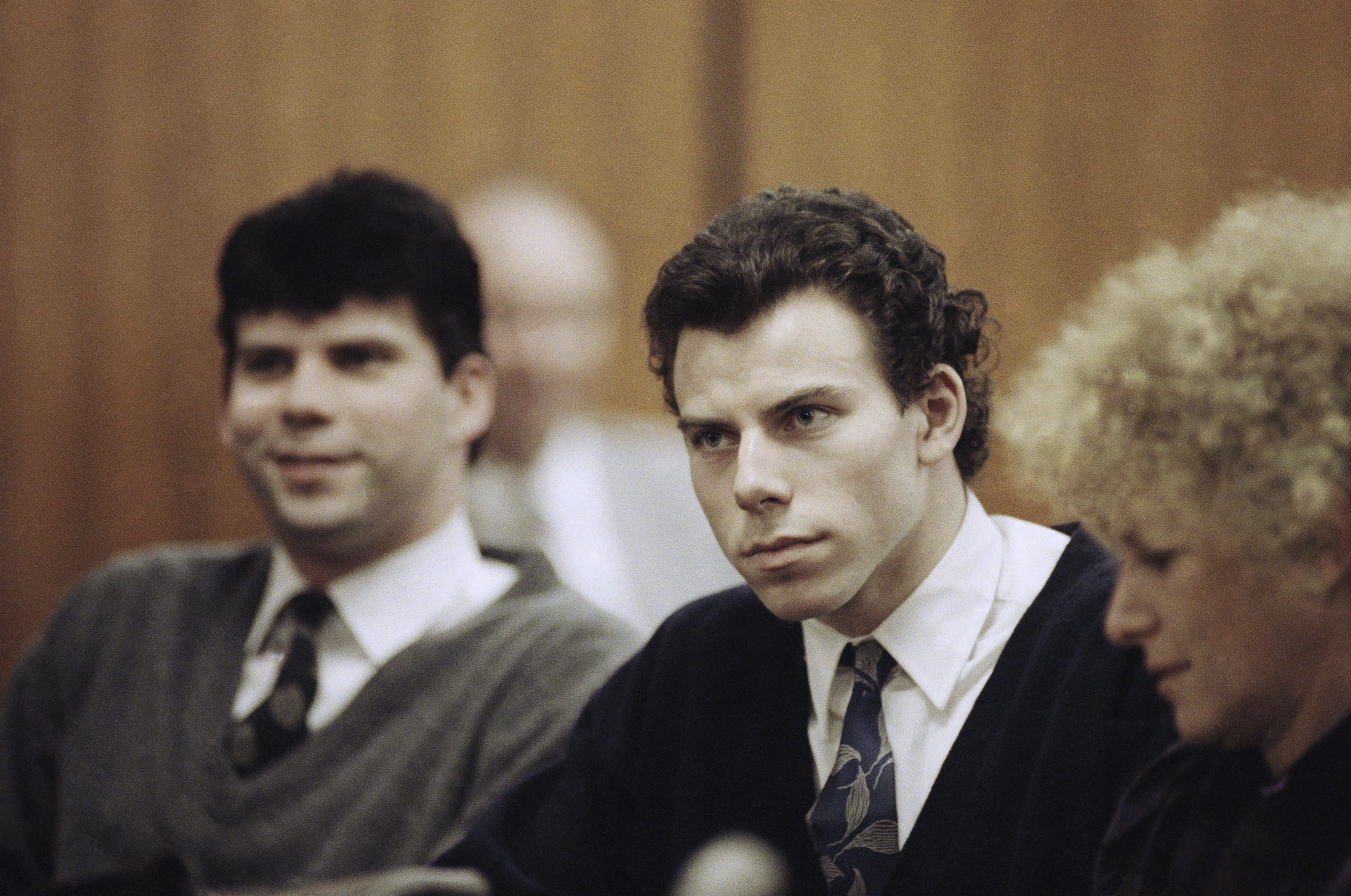 Lyle Menendez, left, and Erik Menendez sit with attorney Leslie Abramson in Beverly Hills Municipal Court Nov. 26, 1990. Prosecutors on Thursday recommended that the Menendez brothers be resentenced for the 1989 killings of their parents in Beverly Hills.