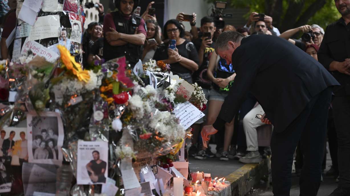 Geoff Payne, right, the father of former One Direction singer Liam Payne, visits a memorial outside the Casa Sur Hotel where the British pop singer fell to his death Oct. 18 in Buenos Aires, Argentina. The police raided the Buenos Aires hotel Wednesday.