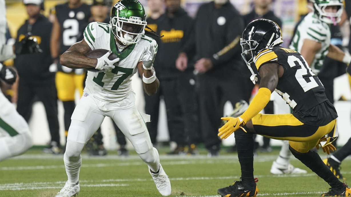 New York Jets wide receiver Davante Adams (17) pulls in a pass reception against Pittsburgh Steelers cornerback Joey Porter Jr. (24) in the first half of an NFL football game in Pittsburgh, Sunday, Oct. 20, 2024.