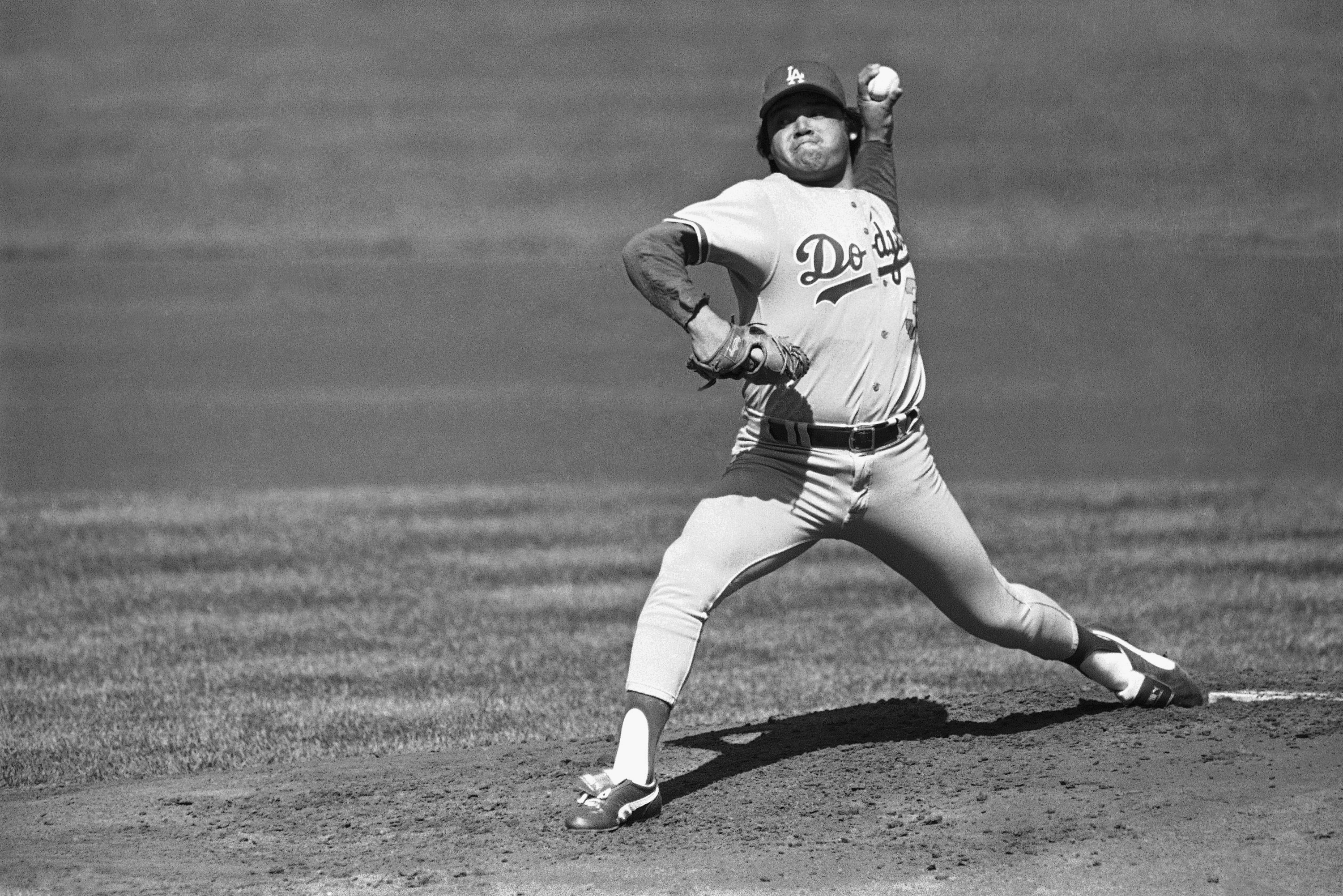 FILE - Los Angeles Dodgers pitcher Fernando Valenzuela pitches against a San Francisco Giants batter during the first inning at Candlestick Park, Oct. 3, 1982, in San Francisco. Fernando Valenzuela, the Mexican-born phenom for the Los Angeles Dodgers who inspired “Fernandomania” while winning the NL Cy Young Award and Rookie of the Year in 1981, has died Tuesday, Oct. 22, 2024.