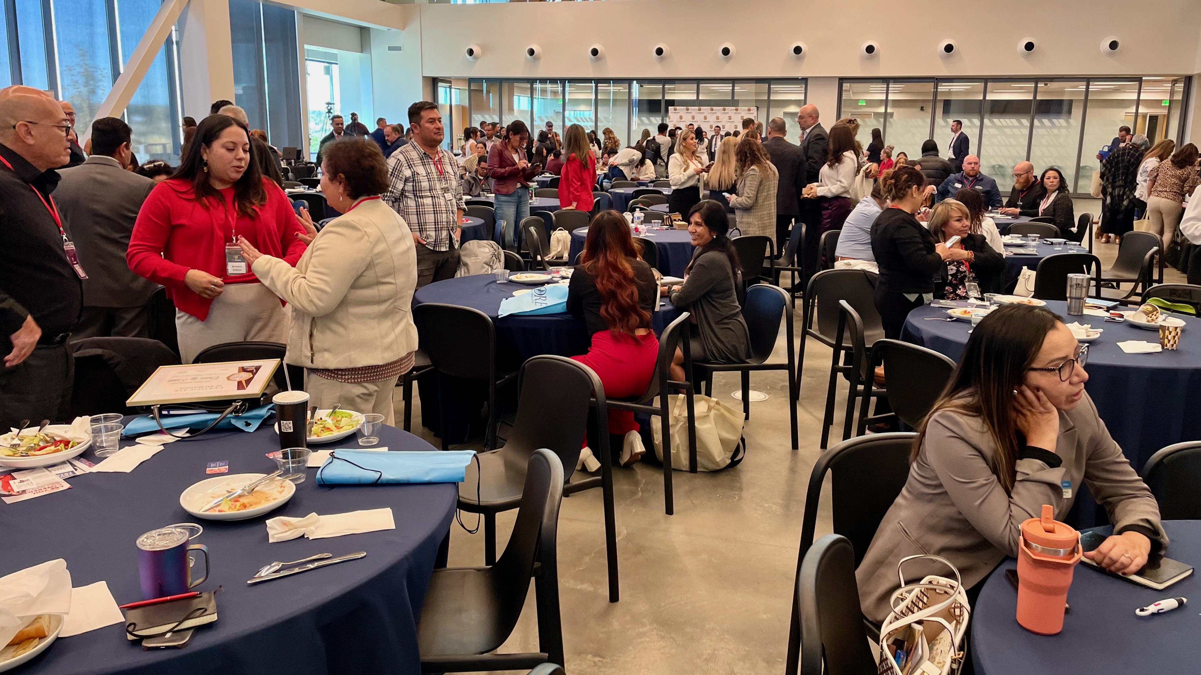 Those attending the annual Utah Hispanic Chamber of Commerce conference in Midvale on Thursday talk between presentations.