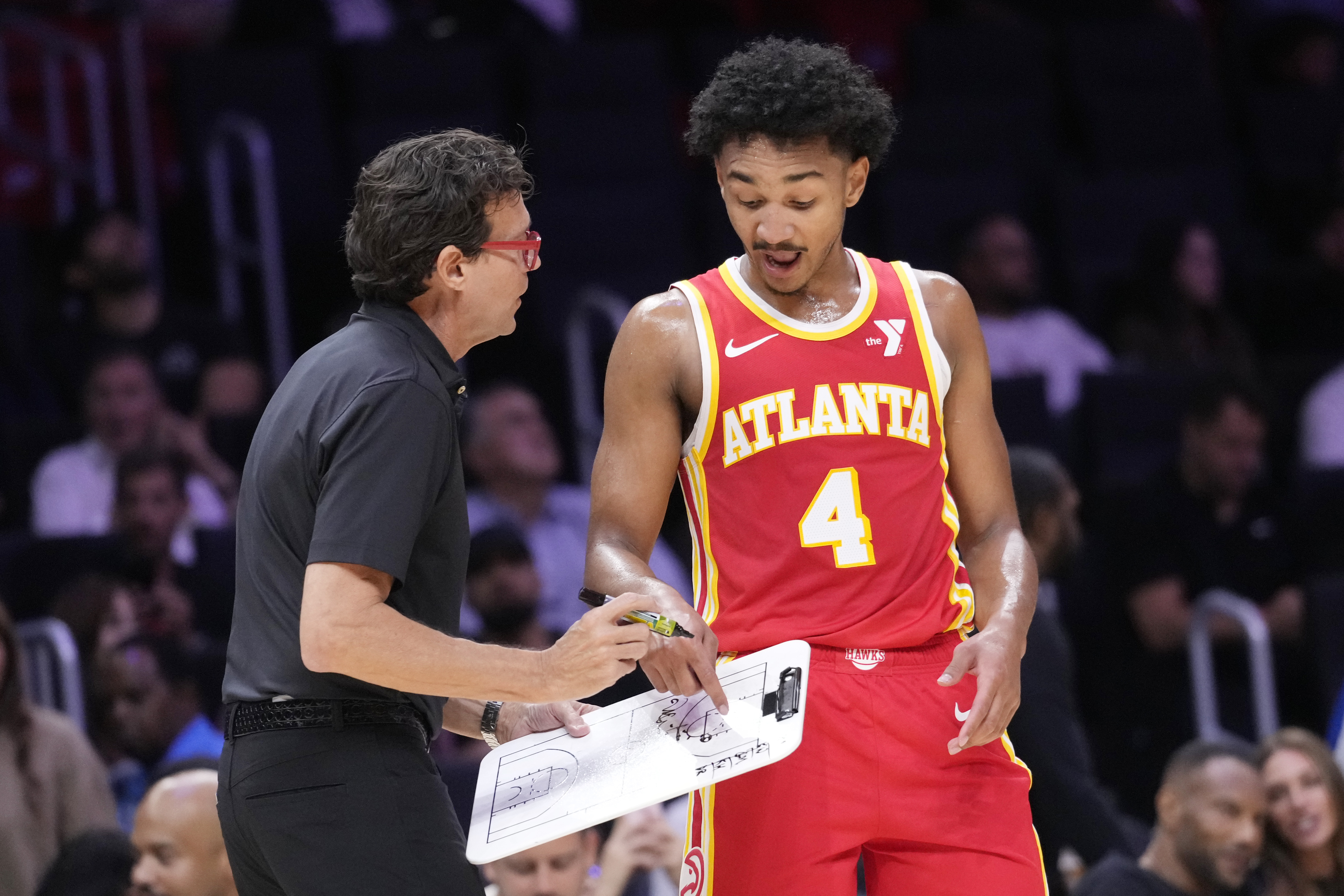 Atlanta Hawks guard Kobe Bufkin (4) talks with head coach Quin Snyder during the second half of an NBA preseason basketball game against the Miami Heat, Wednesday, Oct. 16, 2024, in Miami. 