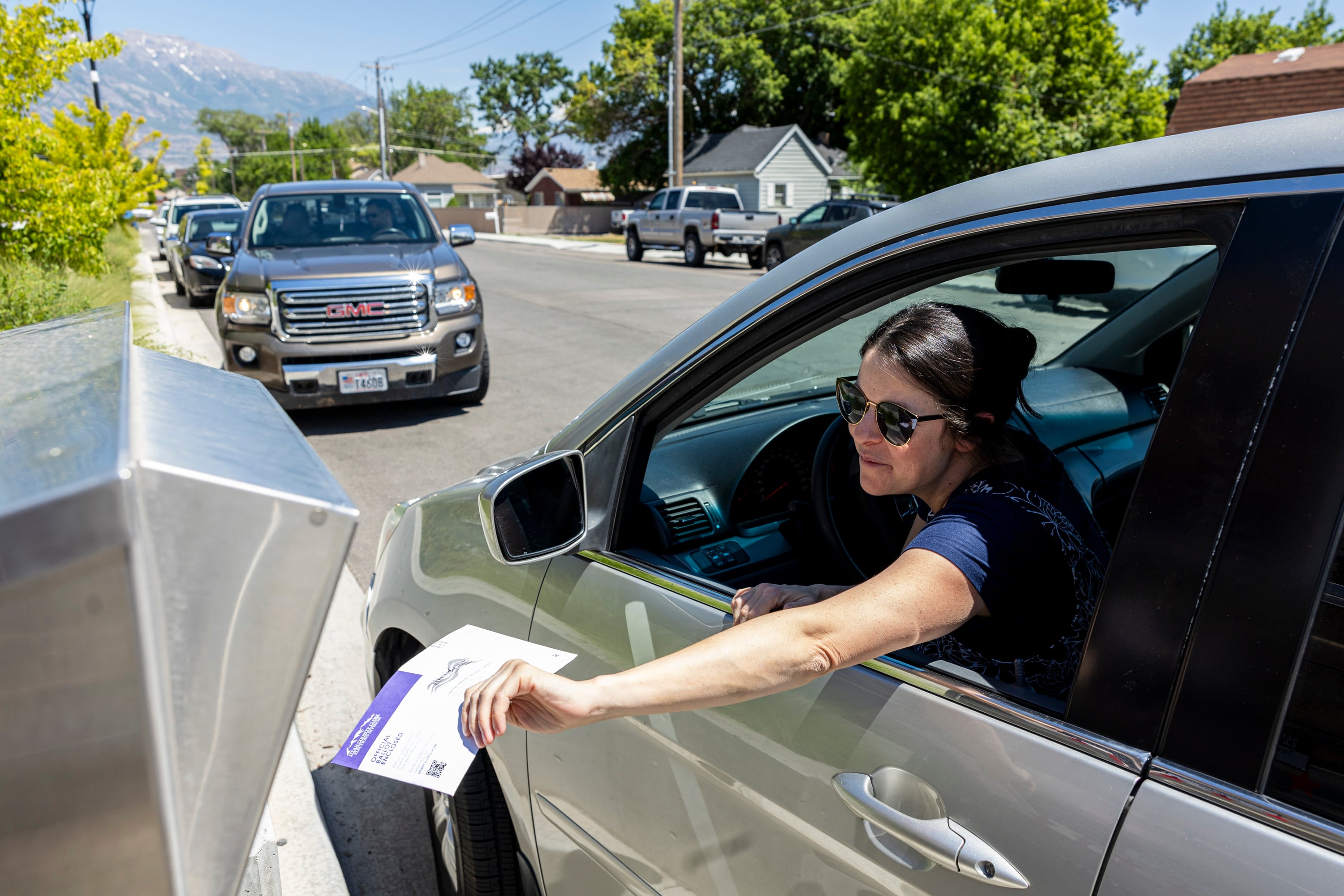 Nicole Bulloch puts her ballot in a drop box during primary election voting held at the Lehi Public Safety Building in Lehi on June 25. An estimated 13% of Utahns have already voted in this year's general election.