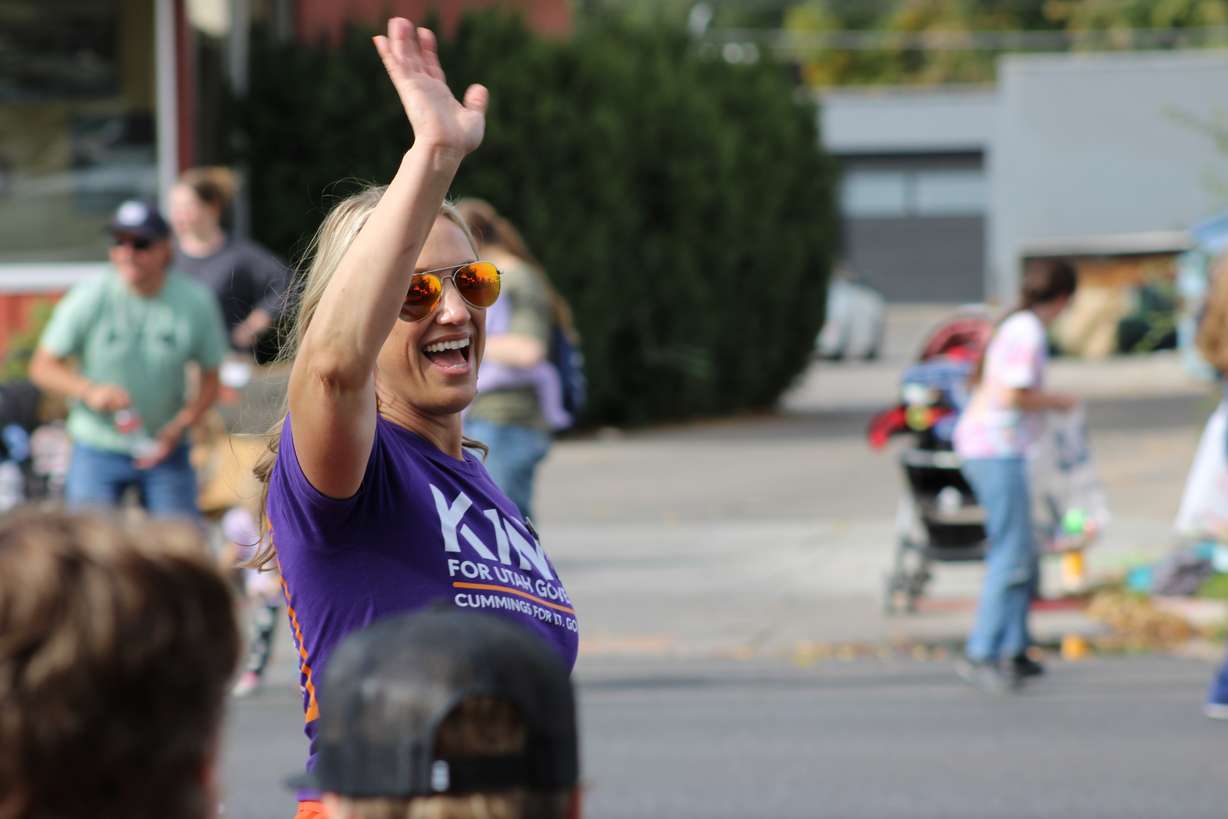 Rebekah Cummings, Democratic candidate for lieutenant governor of Utah, waves to attendees at Utah State University's homecoming parade in Logan on Oct. 12.