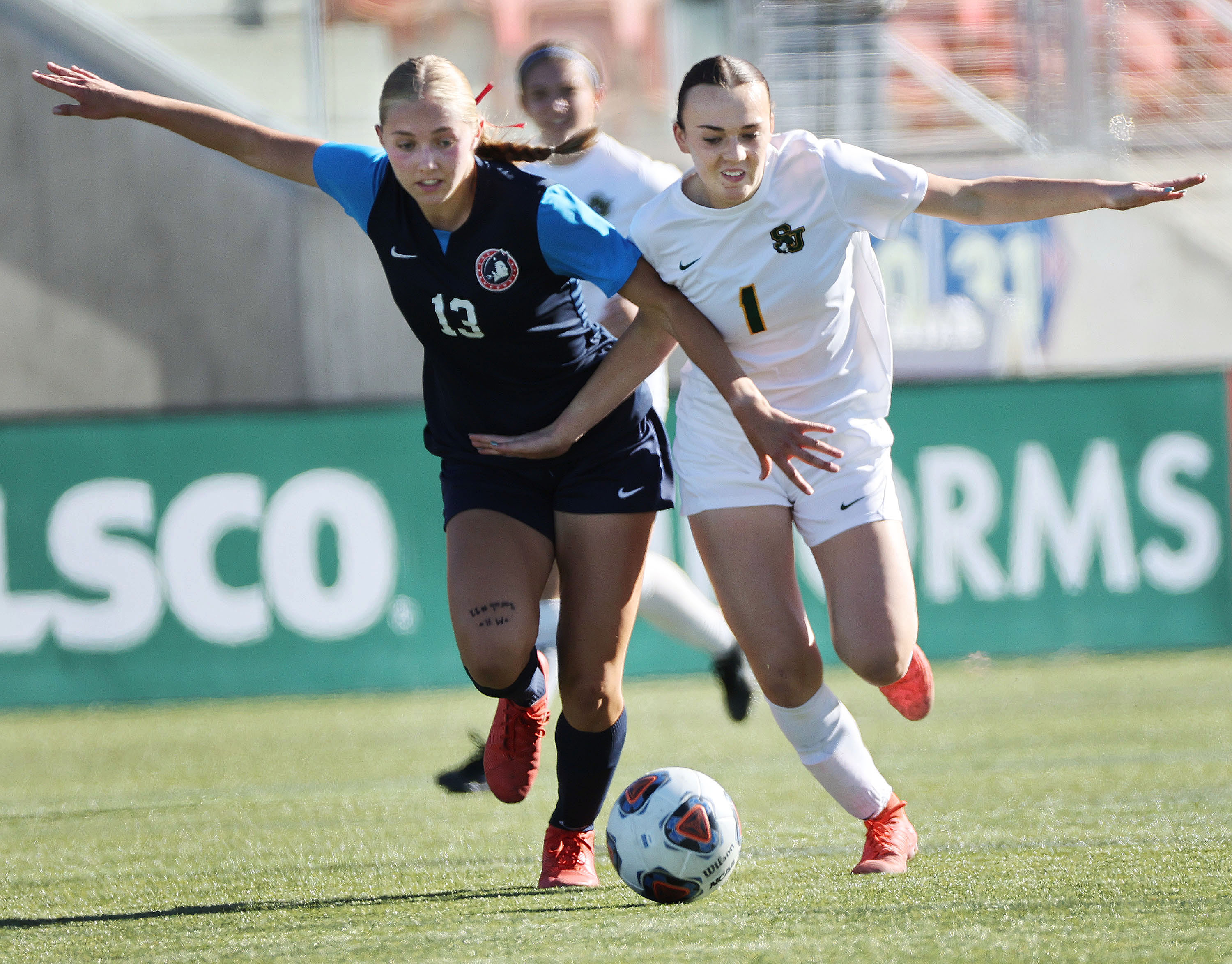 American Heritage’s Bree Harmon (13) competes with St. Joseph’s Preslie Thiel (1) during 2A semifinals soccer at  Zions Bank Stadium in Herriman on Thursday, Oct. 24, 2024.