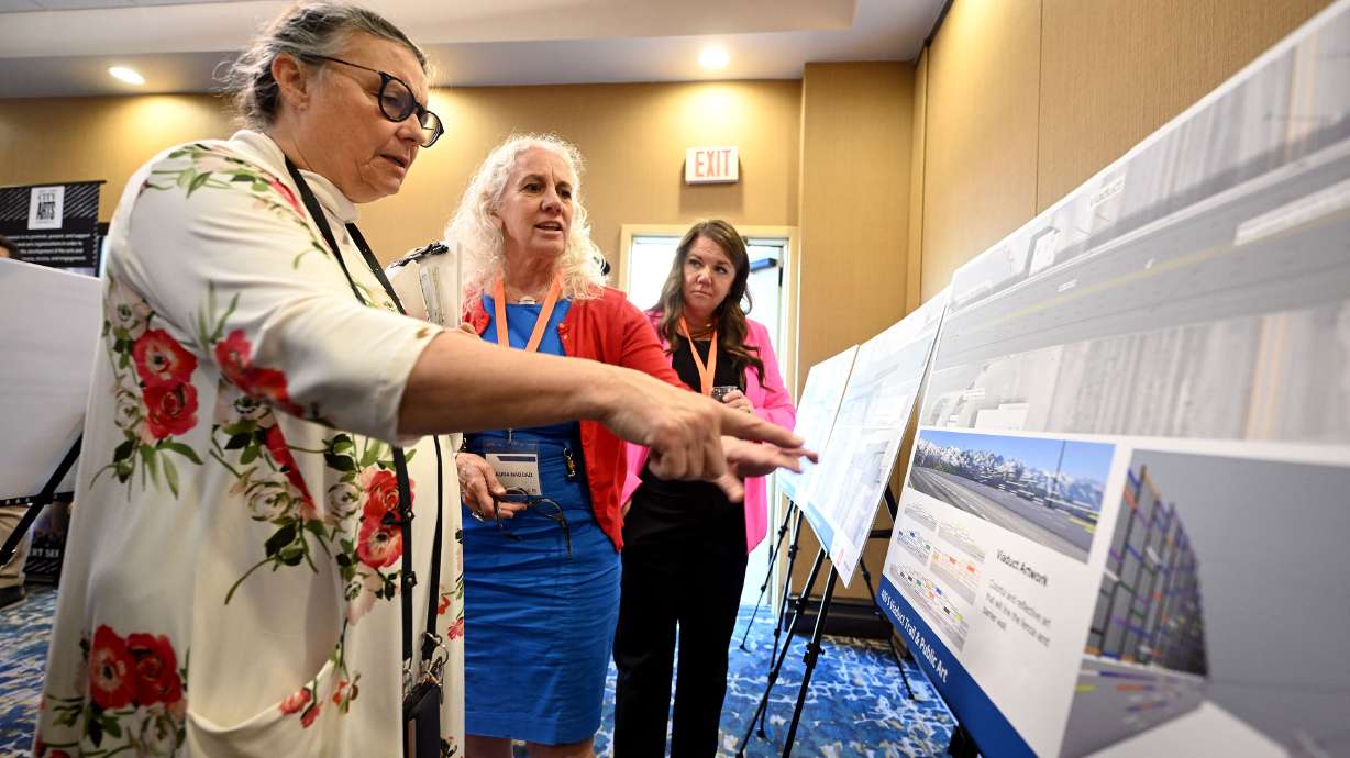 Julie Olson looks over the displays for a new multiuse 400 South trail in Salt Lake City with Laura Haddad and Katie Williams. Olson is hoping that local artists can be included in the project.