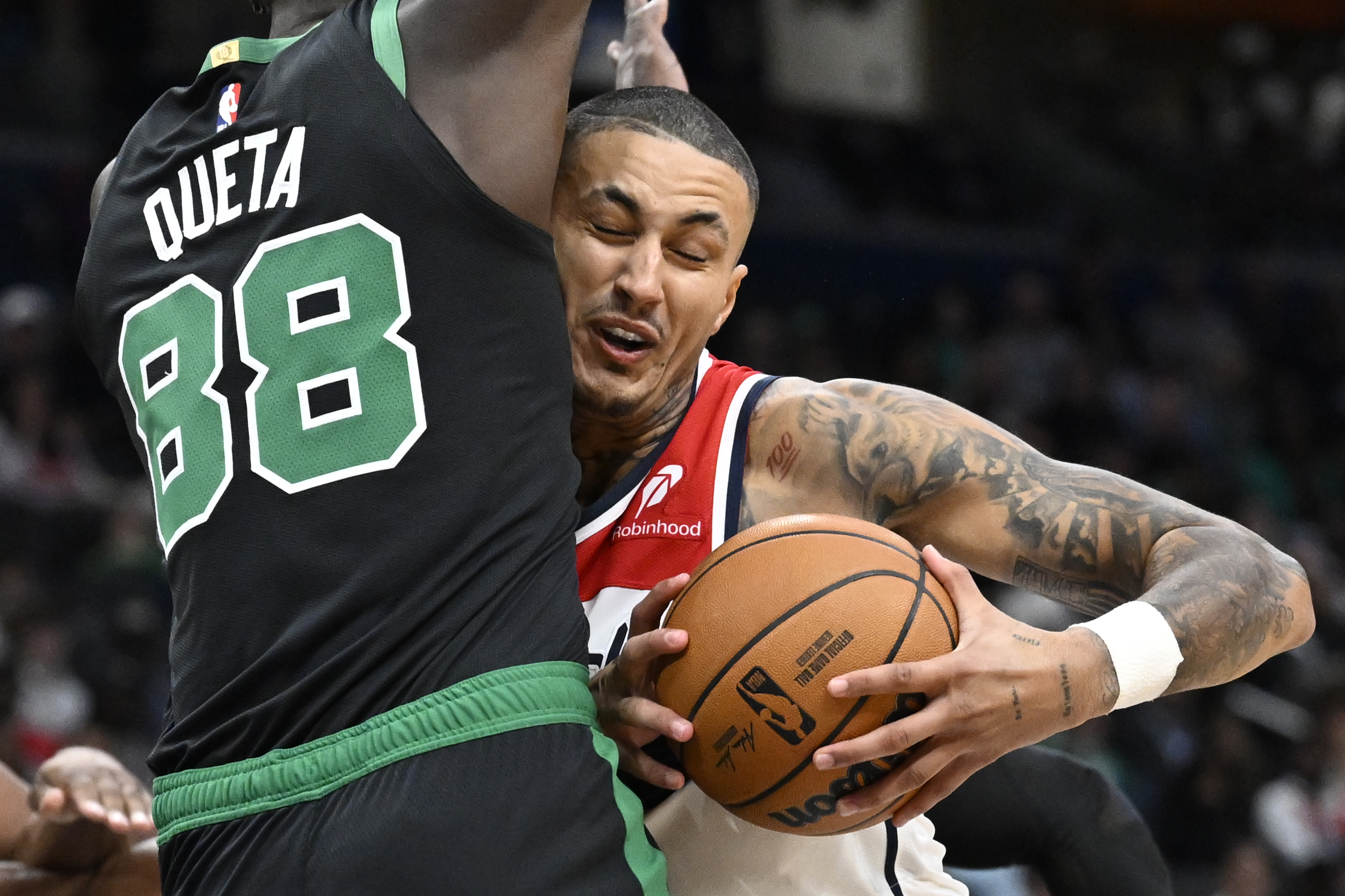 Washington Wizards forward Kyle Kuzma, right, is fouled by Boston Celtics center Neemias Queta (88) during the first half of an NBA basketball game Thursday, Oct. 24, 2024, in Washington.
