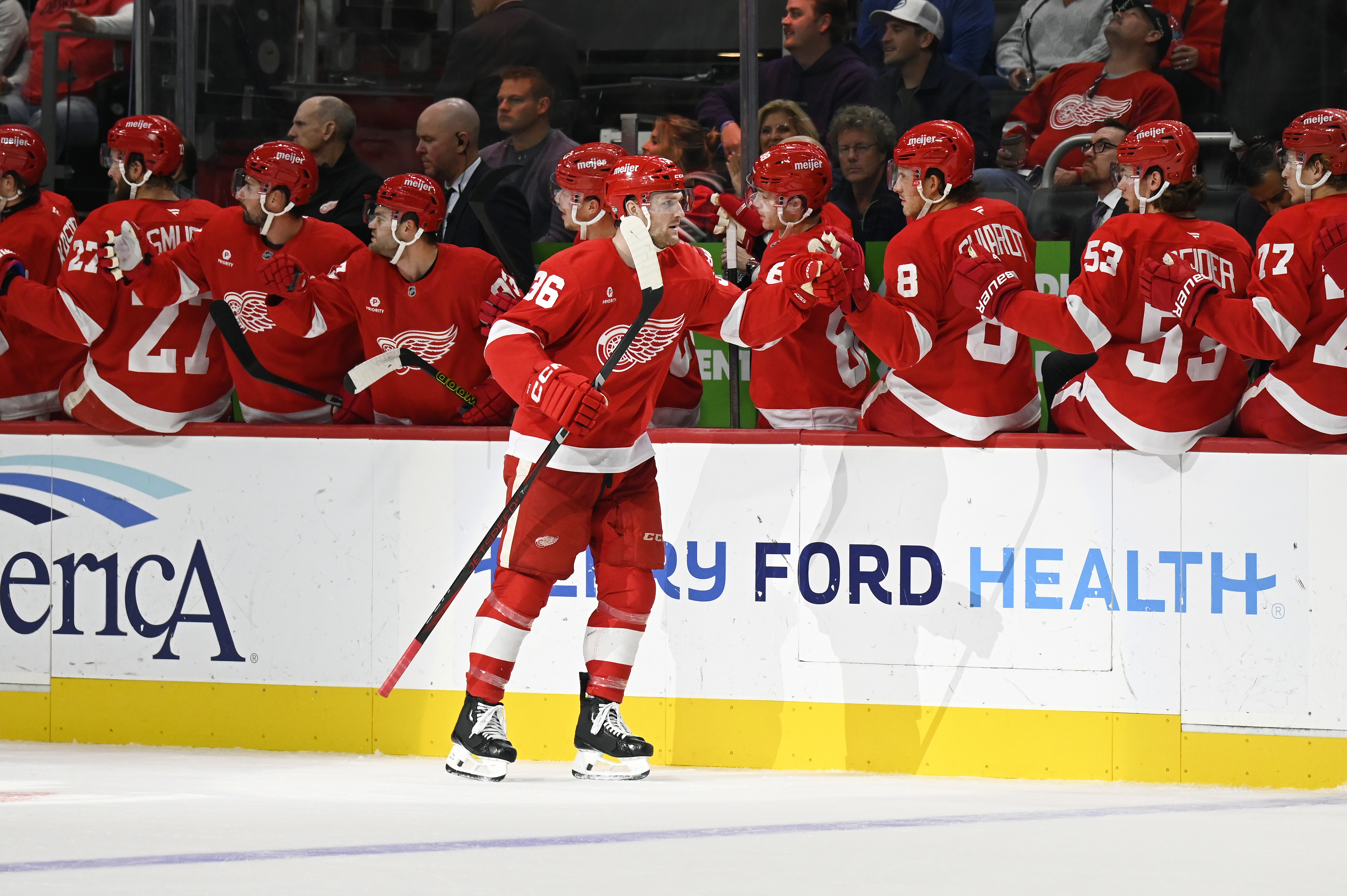 Detroit Red Wings right wing Christian Fischer, foreground, is congratulated after scoring against the New Jersey Devils during the first period of an NHL hockey game, Thursday, Oct. 24, 2024, in Detroit. 