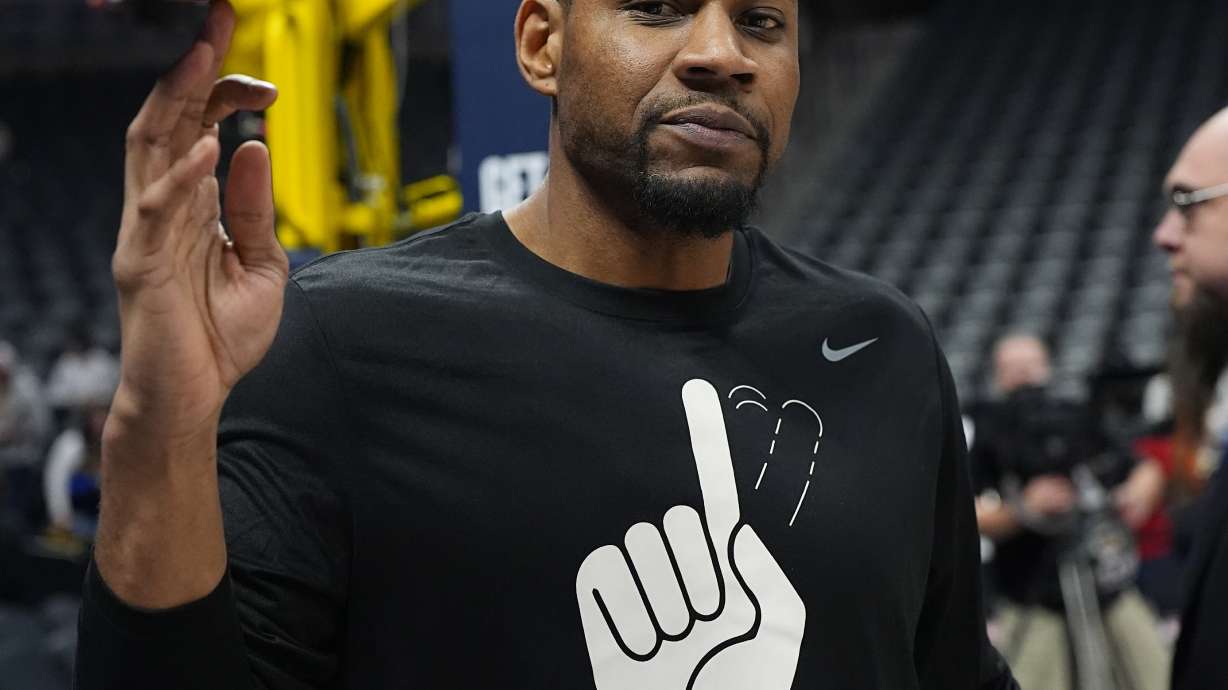 Denver Nuggets development coach Stephen Graham wears a shirt in honor of former Nuggets center Dikemba Mutombo who died last month as players warm up before an NBA basketball game against the Oklahoma City Thunder Thursday, Oct. 24, 2024 in Denver.