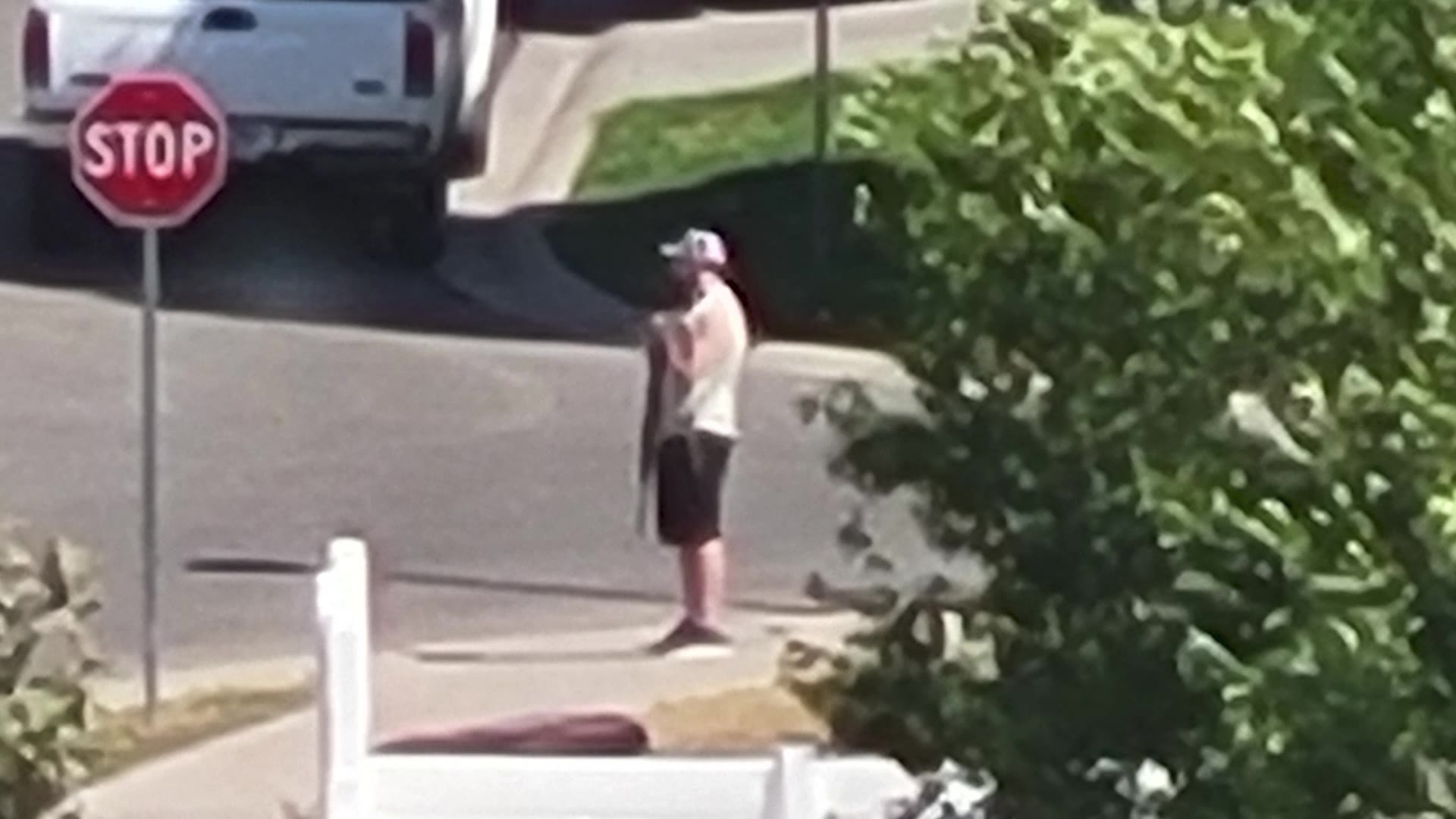 A man stands on the corner of a street in West Valley City holding a semiautomatic rifle. Residents are concerned the situation may escalate.