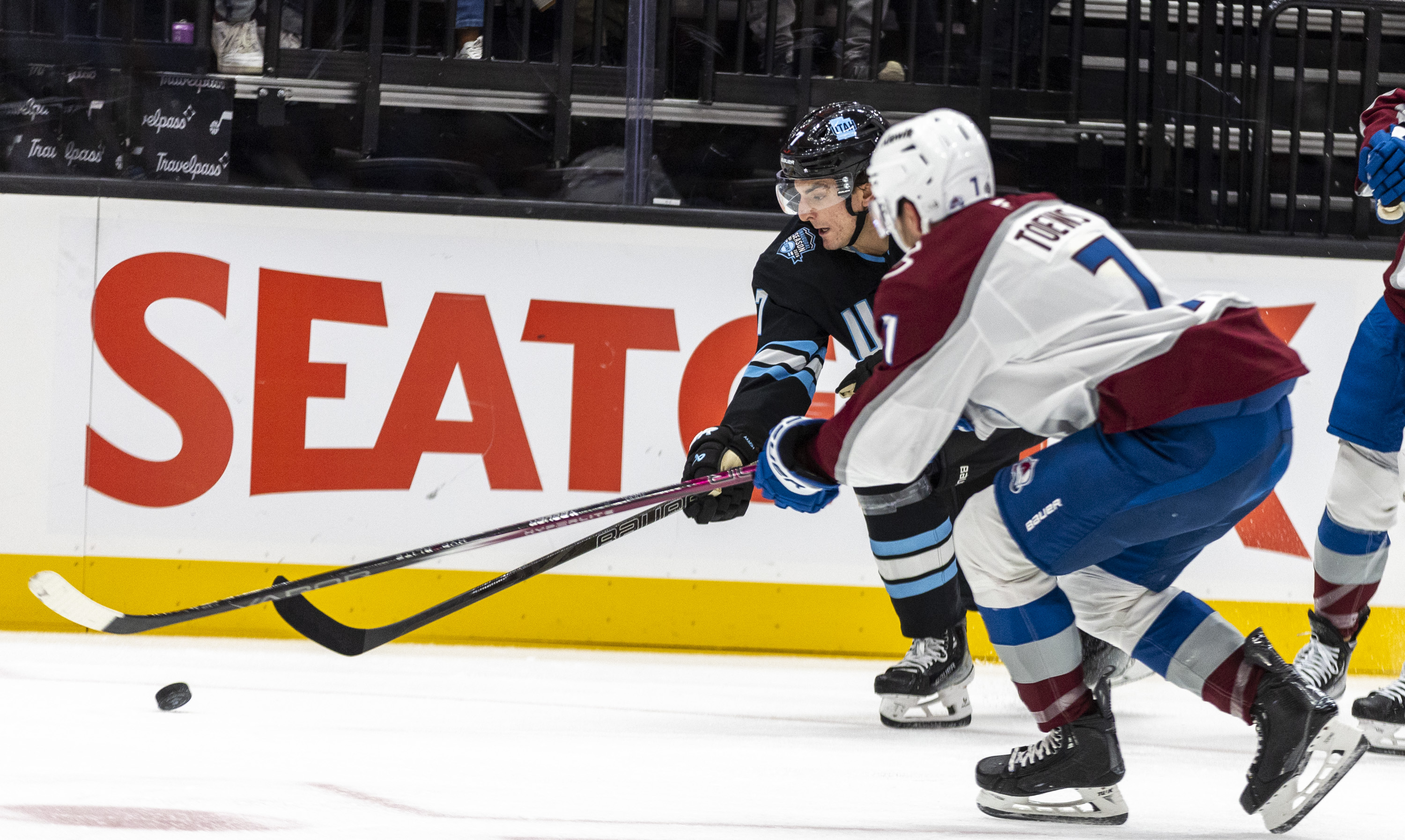 Utah Hockey Club defenseman Michael Kesselring (7) and Colorado Avalanche defenseman Devon Toews (7) battle for control of the puck during a game at the Delta Center in Salt Lake City on Thursday, Oct. 24, 2024.