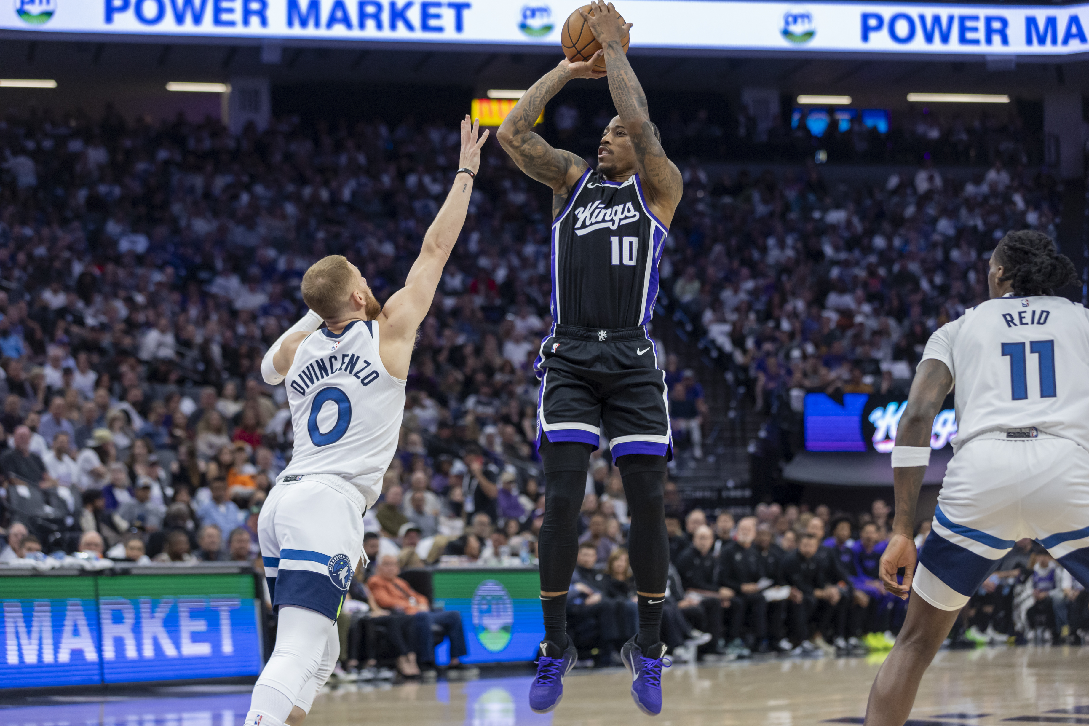 Sacramento Kings forward DeMar DeRozan (10) makes a jump shot over Minnesota Timberwolves guard Donte DiVincenzo (0) during the first half of an NBA basketball game Thursday, Oct. 24, 2024, in Sacramento, Calif. 