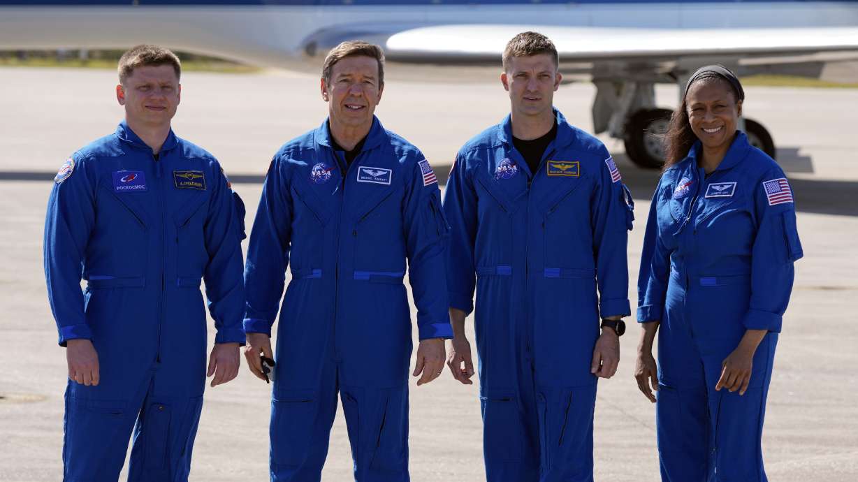 The SpaceX crew of the Dragon spacecraft, from left, cosmonaut Alexander Grebenkin, pilot Michael Barratt, commander Matthew Dominick and mission specialist Jeanette Epps gather for a photo after arriving at the Kennedy Space Center in Cape Canaveral, Fla., Feb. 25. They returned to Earth Friday.
