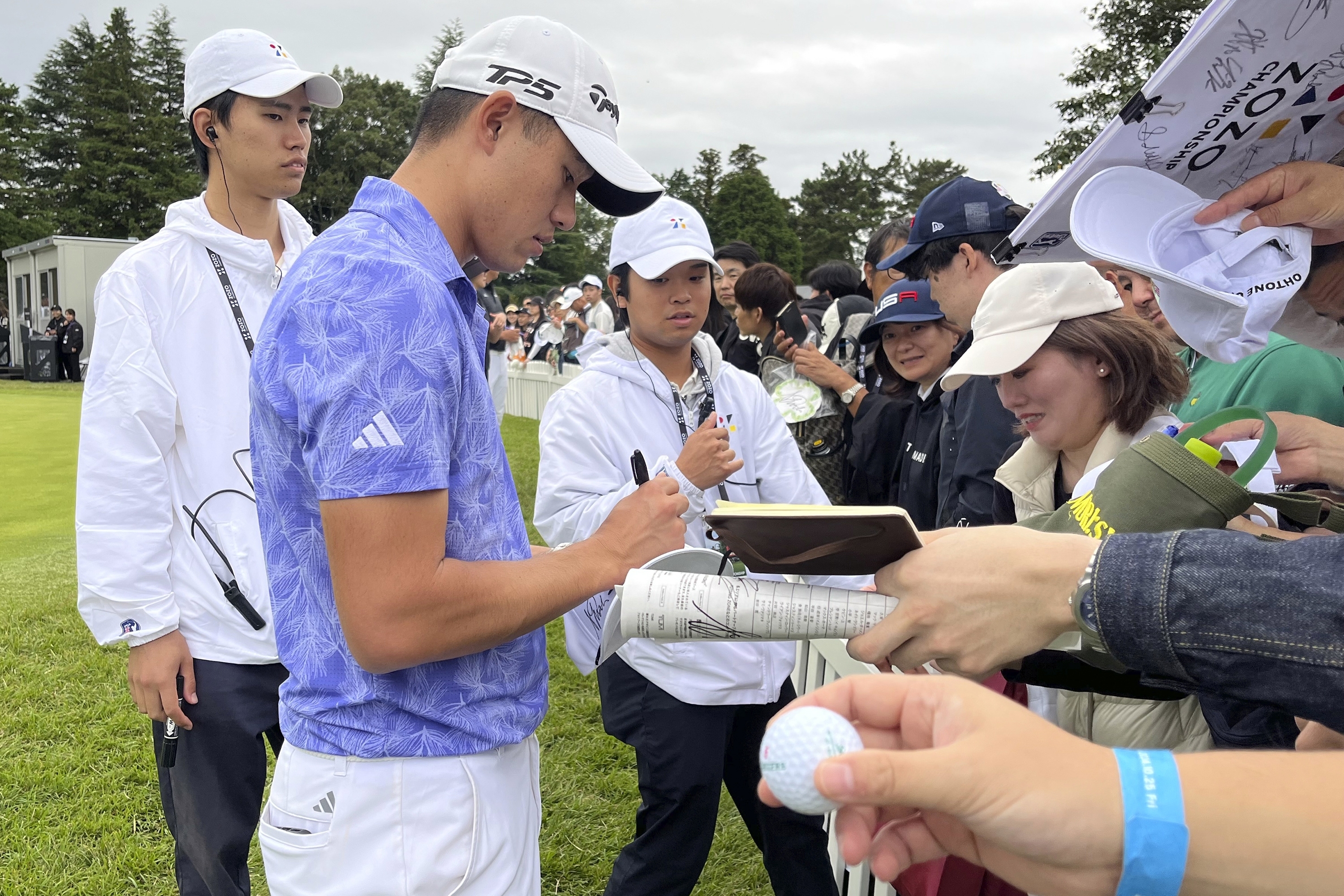 Collin Morikawa, the defending Zozo champion, signs autographs after his second round of the PGA Tour Zozo Championship at the Narashino Country Club in Inzai on the outskirts of Tokyo, Friday, Oct. 25, 2024. 