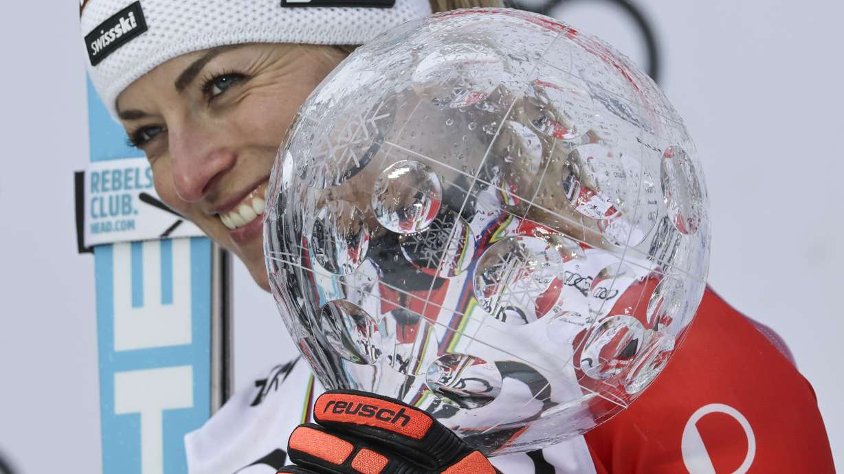 FILE - Switzerland's Lara Gut Behrami poses with the alpine ski, women's World Cup overall trophy, in Saalbach, Austria, on March 23, 2024.