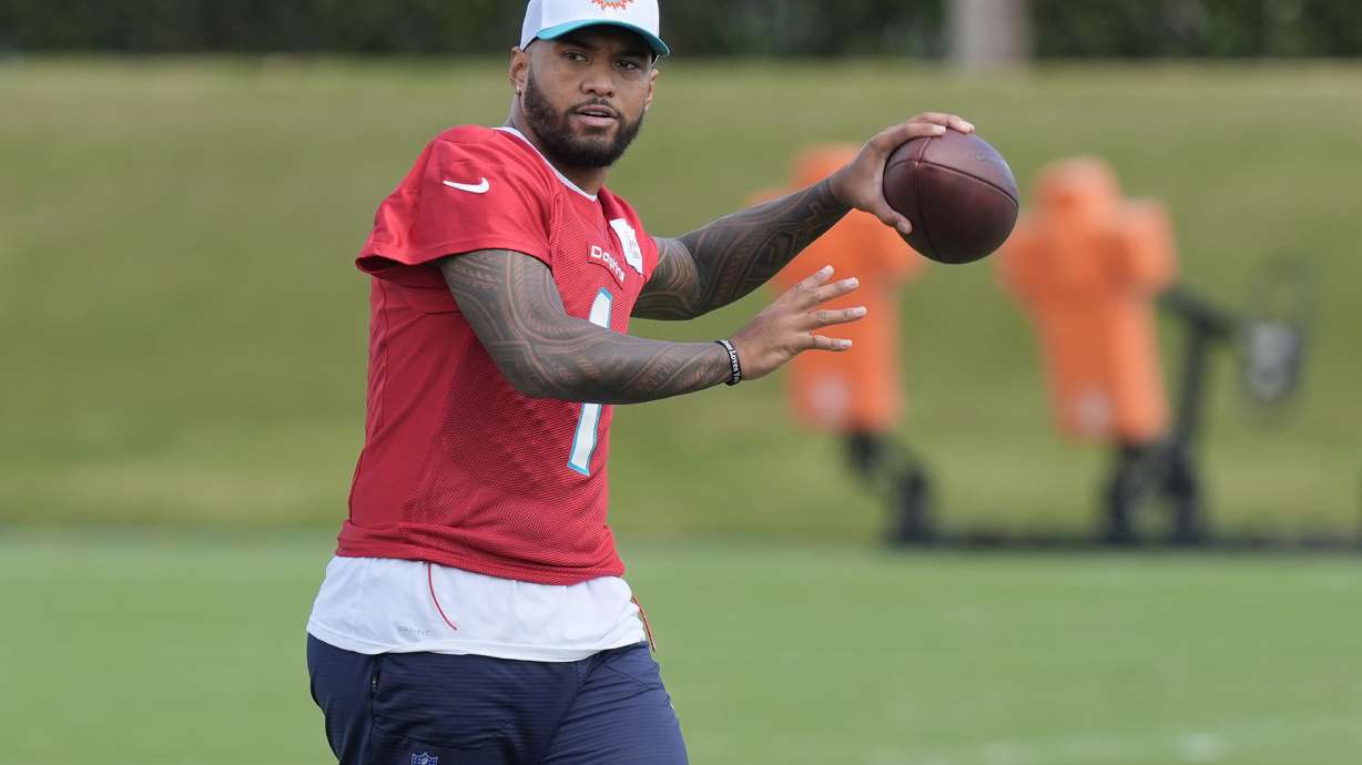 Miami Dolphins quarterback Tua Tagovailoa (1) aims the ball during a practice session at the team's training facility, Wednesday, Oct. 23, 2024, in Miami Gardens, Fla.