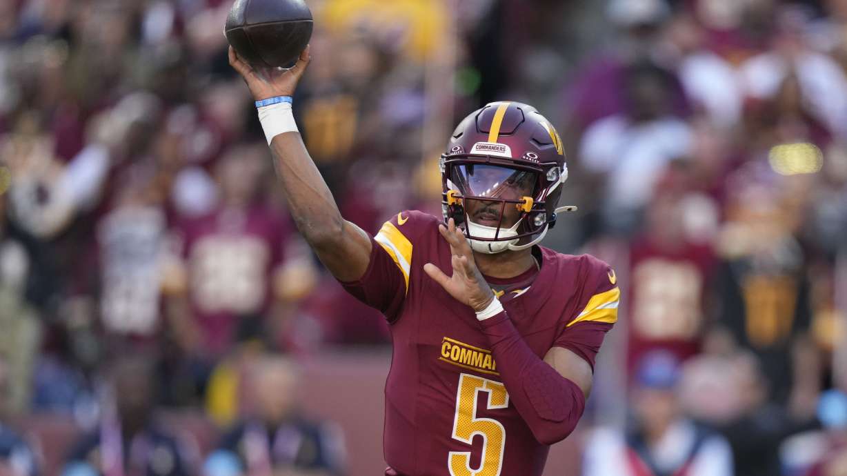 Washington Commanders quarterback Jayden Daniels throws a pass during the first half of an NFL football game against the Carolina Panthers, Sunday, Oct. 20, 2024, in Landover, Md.