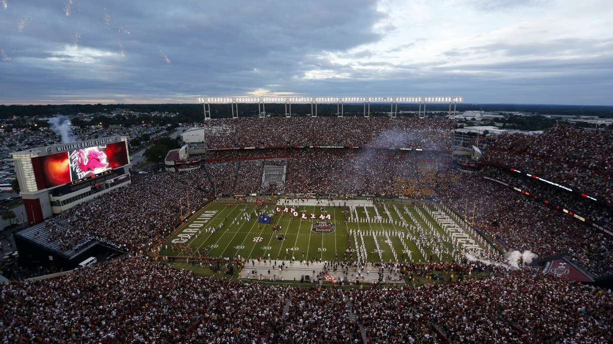 FILE - Fans cheer as South Carolina takes the field at Williams-Brice Stadium before the start of an NCAA college football game against Missouri, Sept. 27, 2014, in Columbia, S.C.