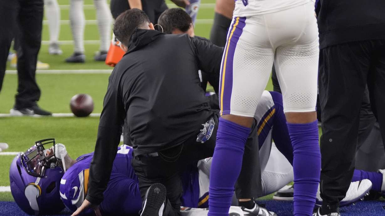 Minnesota Vikings offensive tackle Christian Darrisaw (71) is attended to after sustaining an injury during the first half of an NFL football game against the Los Angeles Rams, Thursday, Oct. 24, 2024, in Inglewood, Calif.