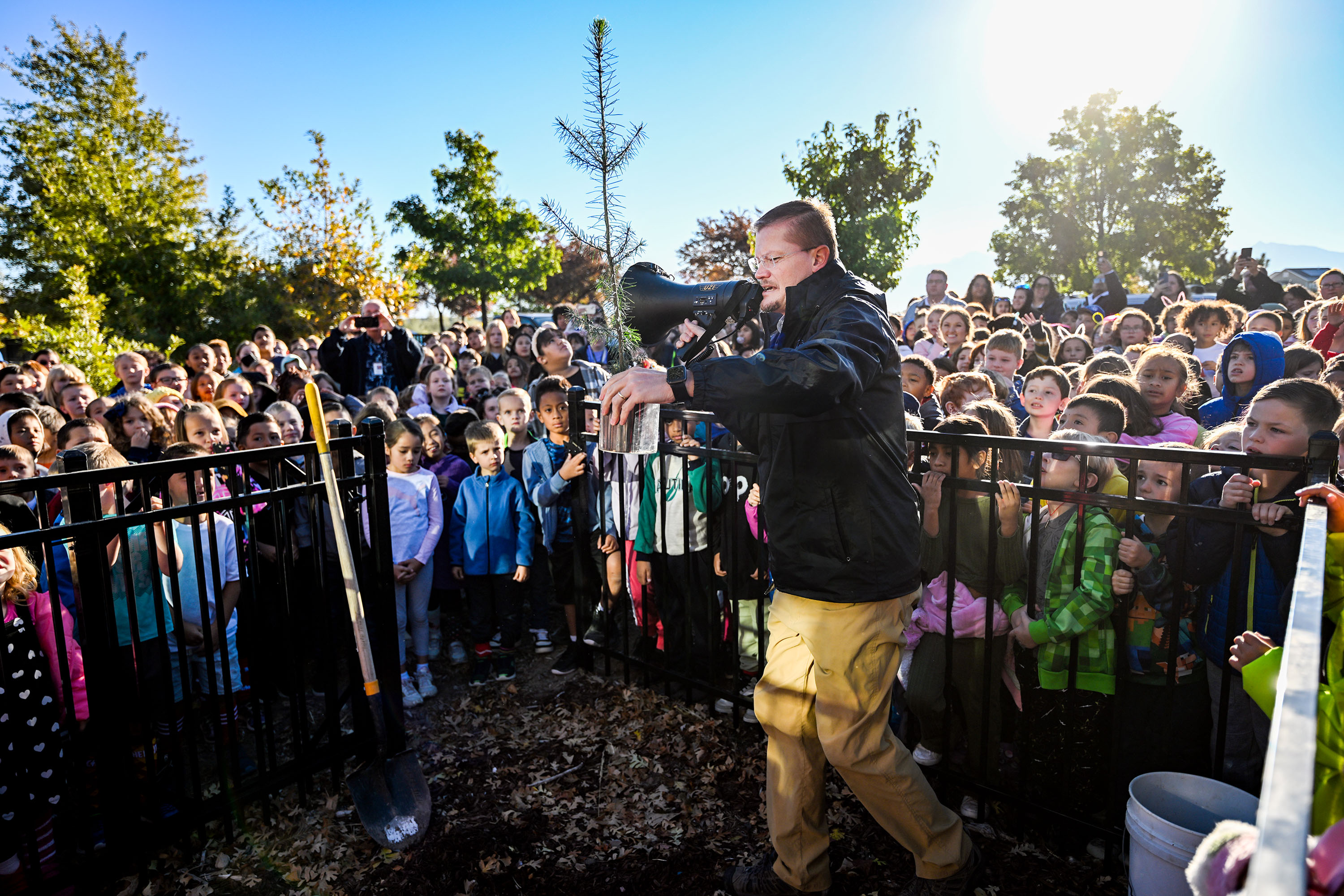 John Paul Sorensen, principal of Neil Armstrong Academy, holds a moon tree sapling up for all the students and teachers to see before planting it in West Valley City on Friday. The school received a moon tree from the Artemis I Mission.