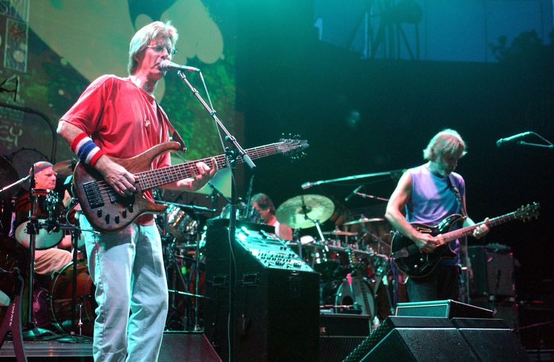 Former bassist for the Grateful Dead Phil Lesh (L) performs with surviving bandmates Bob Weir, (R) and drummers Bill Kreutzman (Far L) and Mickey Hart, at the Alpine Valley Music Center in East Troy, Wisconsin, late Aug. 3, 2002.