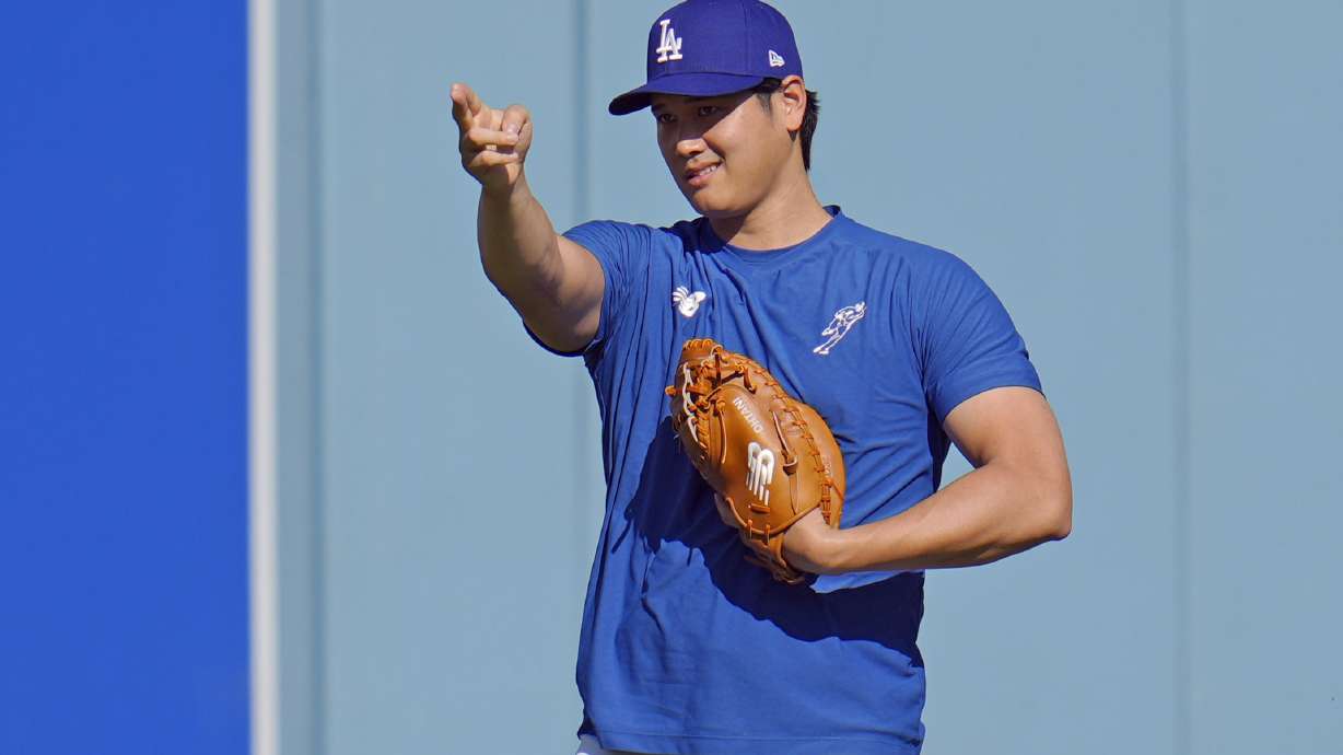 Los Angeles Dodgers Shohei Ohtani gestures during batting practice before Game 1 of the baseball World Series, Friday, Oct. 25, 2024, in Los Angeles.