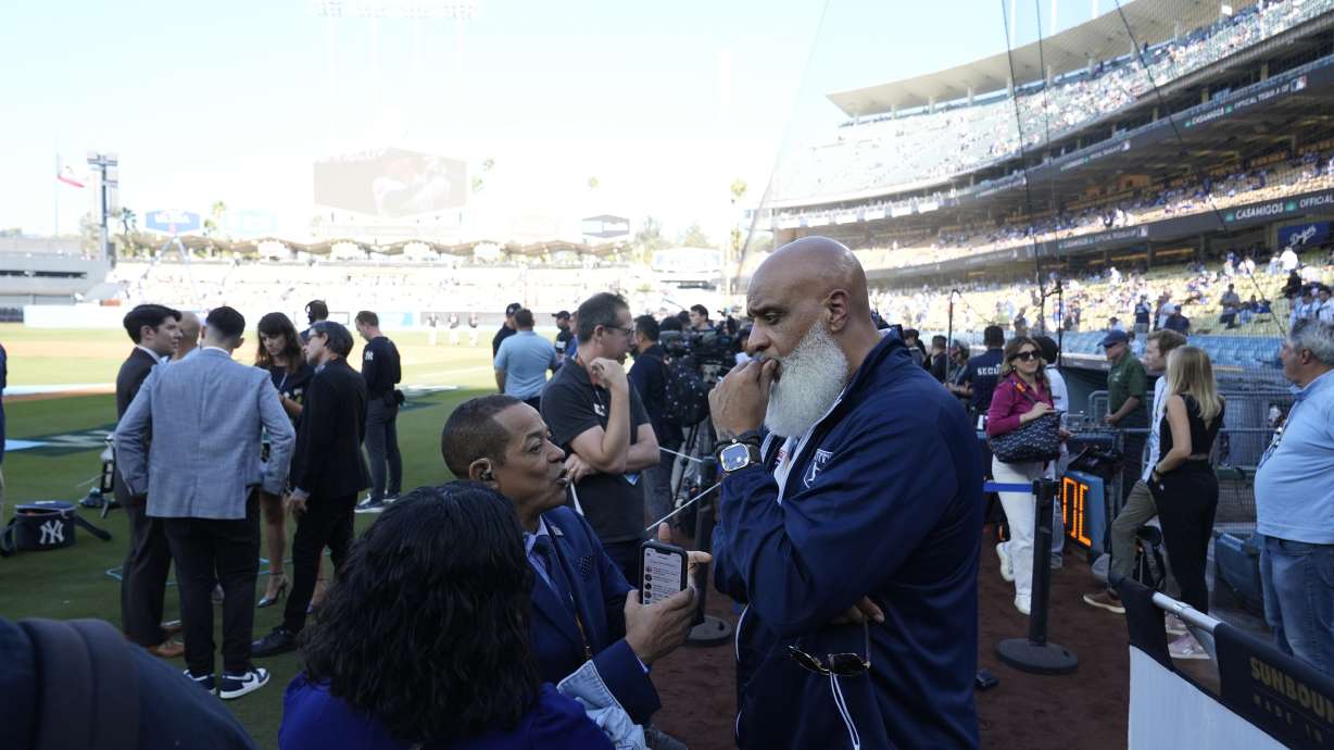 Tony Clark, right, Executive director of the Major League Baseball Players Association, talks with reporters before Game 1 of the baseball World Series, Friday, Oct. 25, 2024, in Los Angeles.