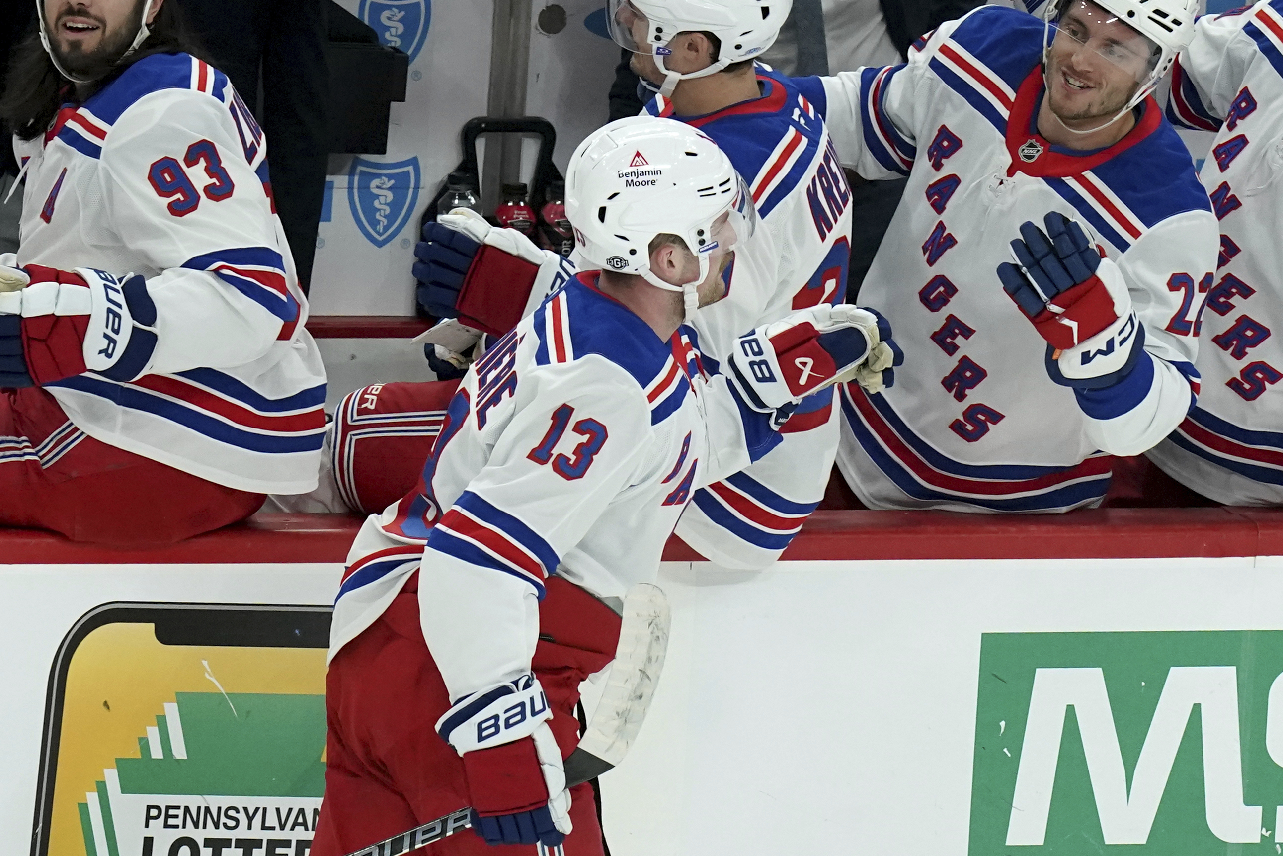 New York Rangers' Alexis Lafreniere (13) returns to the bench after scoring during the first period of an NHL hockey game against the Pittsburgh Penguins, Wednesday, Oct. 9, 2024, in Pittsburgh.