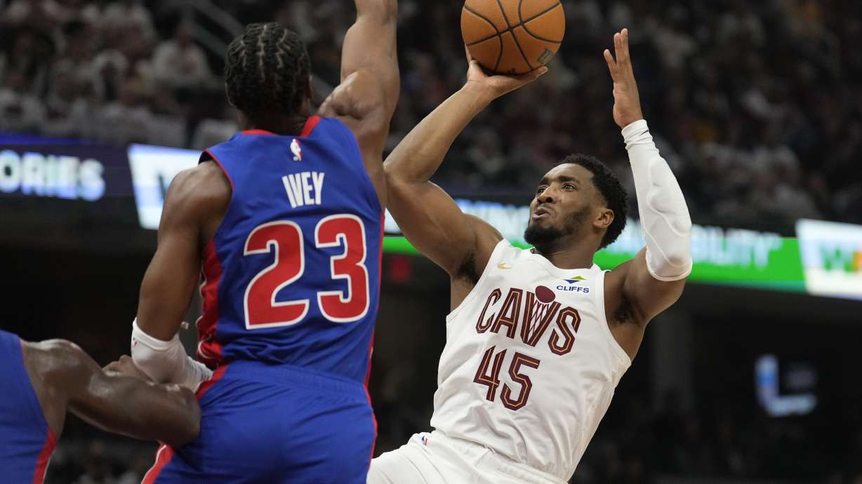 Cleveland Cavaliers guard Donovan Mitchell (45) looks to shoot as Detroit Pistons guard Jaden Ivey (23) defends in the first half of an NBA basketball game, Friday, Oct. 25, 2024, in Cleveland.