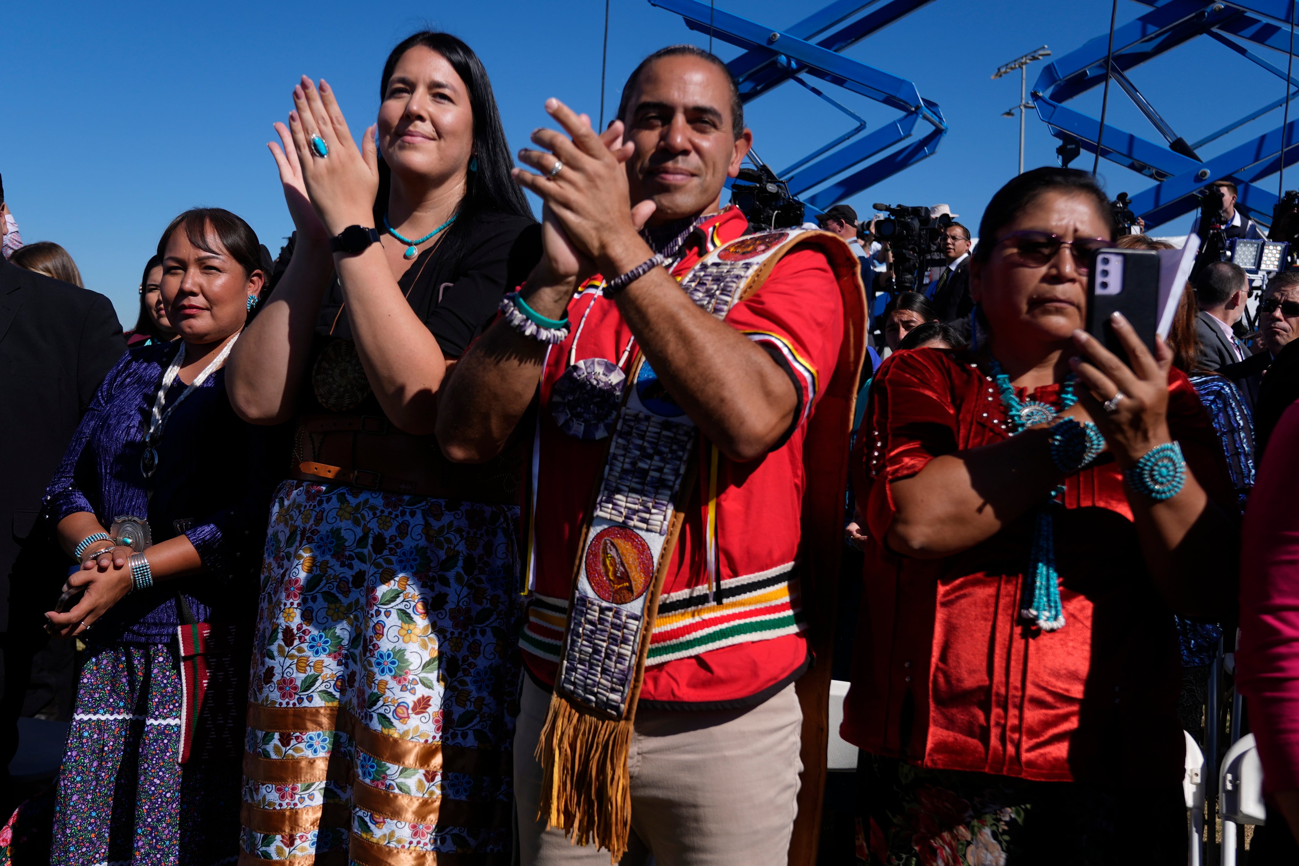 Attendees clap at an event with President Joe Biden at the Gila Crossing Community School in the Gila River Indian Community reservation in Laveen, Ariz., Friday, Oct. 25, 2024.