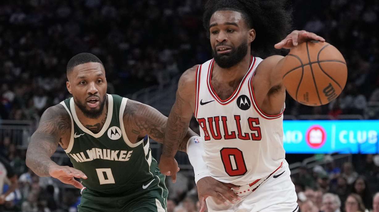 Chicago Bulls' Coby White tries to get past Milwaukee Bucks' Damian Lillard during the second half of an NBA basketball game Friday, Oct. 25, 2024, in Milwaukee.