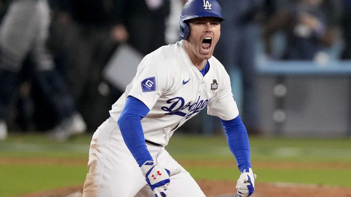 Los Angeles Dodgers' Freddie Freeman celebrates after hitting a walk-off grand slam home run during the 10th inning in Game 1 of the baseball World Series against the New York Yankees, Friday, Oct. 25, 2024, in Los Angeles.