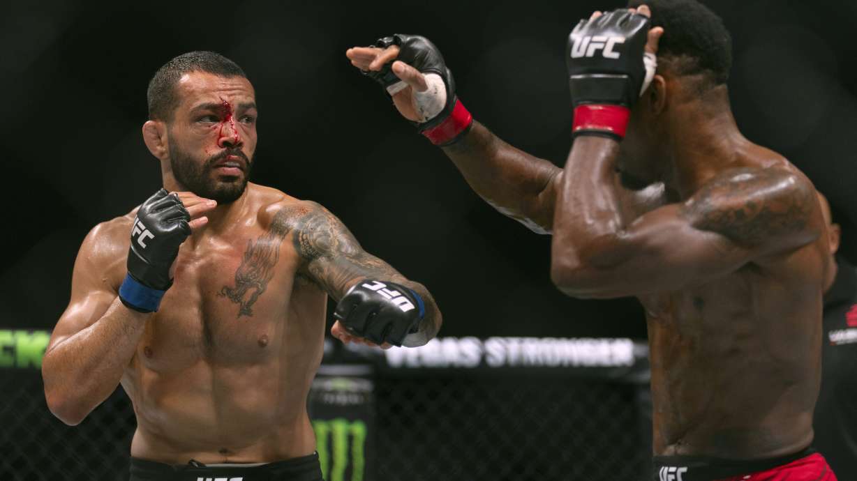 Lerone Murphy, right, fights with Dan Ige during a featherweight mixed martial arts bout at UFC Fight Night on Saturday, Oct. 26, 2024, in Abu Dhabi, United Arab Emirates.