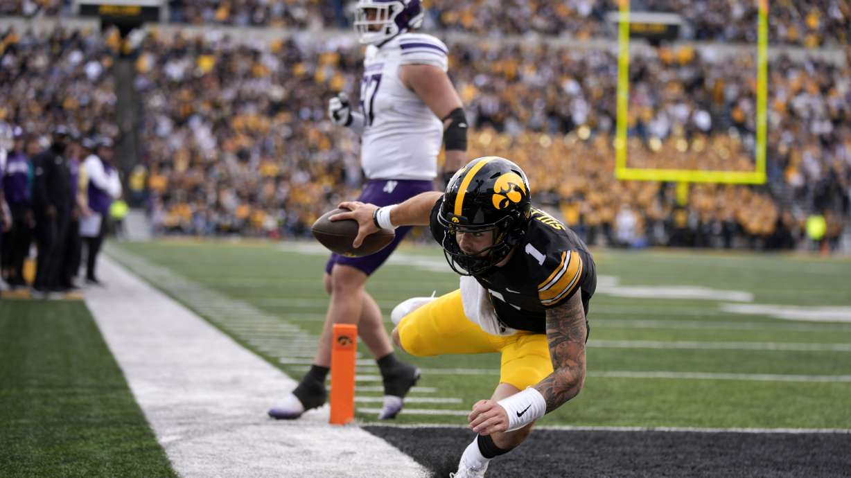 Iowa quarterback Brendan Sullivan (1) scores on a 6-yard touchdown run during the second half of an NCAA college football game against Northwestern, Saturday, Oct. 26, 2024, in Iowa City, Iowa.