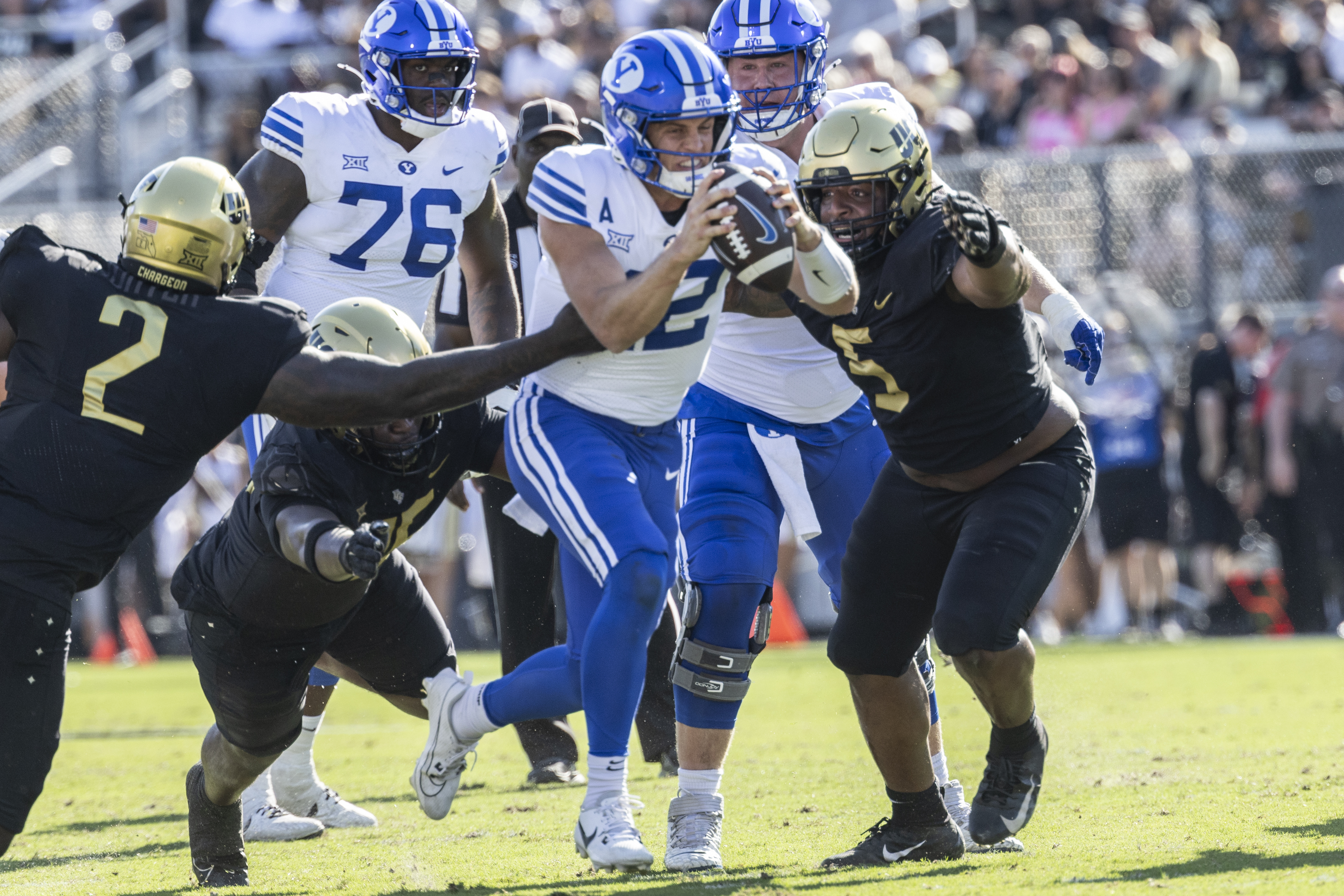 BYU quarterback Jake Retzlaff, Center, is sacked by Central Florida's defense during the first half of an NCAA college football game, Saturday, Oct. 26, 2024, in Orlando, Fla.