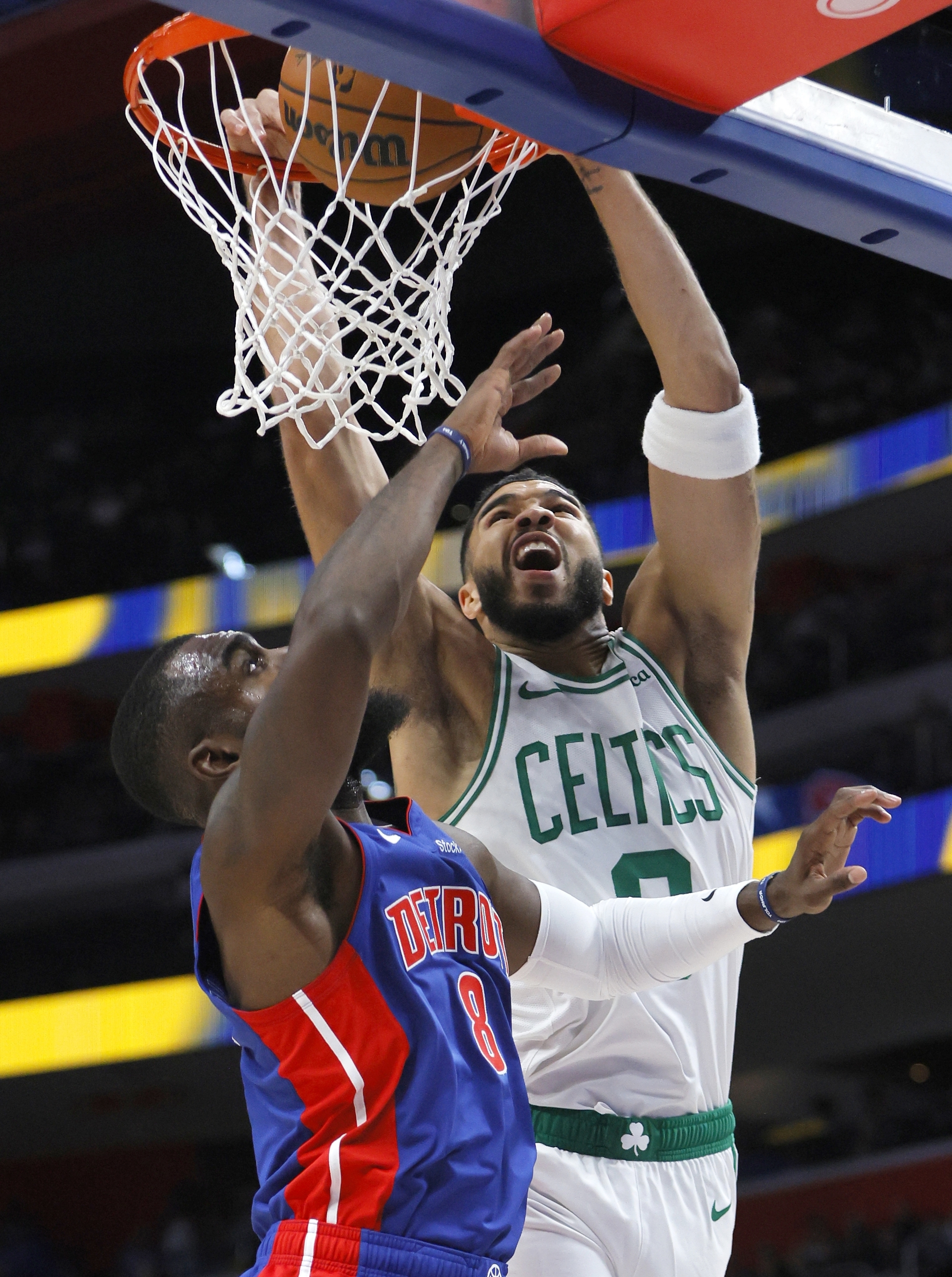 Boston Celtics forward Jayson Tatum (0) dunks over Detroit Pistons forward Tim Hardaway Jr. (8) during the first half of an NBA basketball game Saturday, Oct. 26, 2024, in Detroit. 